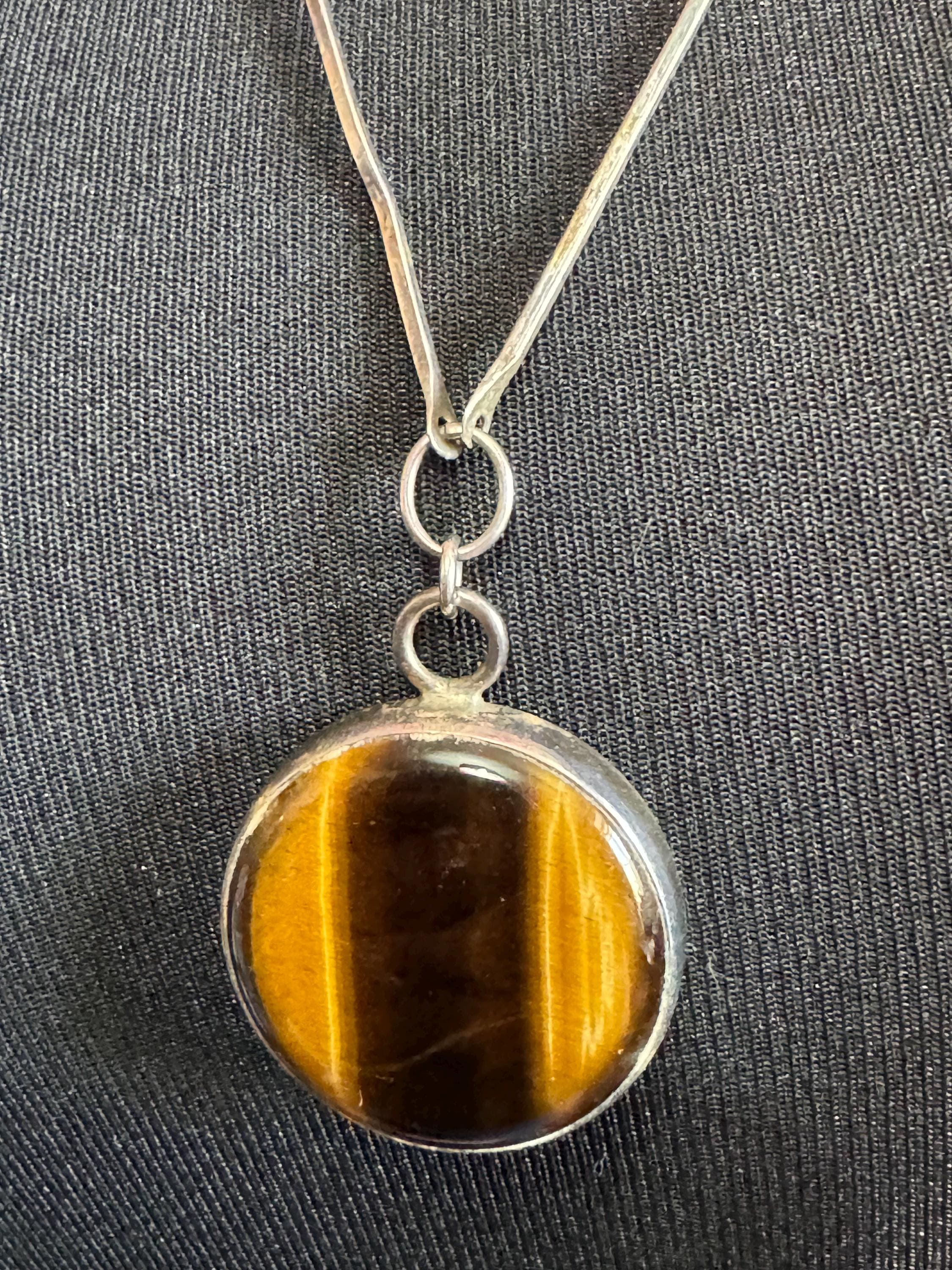 Solid silver long tigers eye round pendant necklace on 75cm chain 917 grade Naples or Malta 1970s weighs 25.5 grams