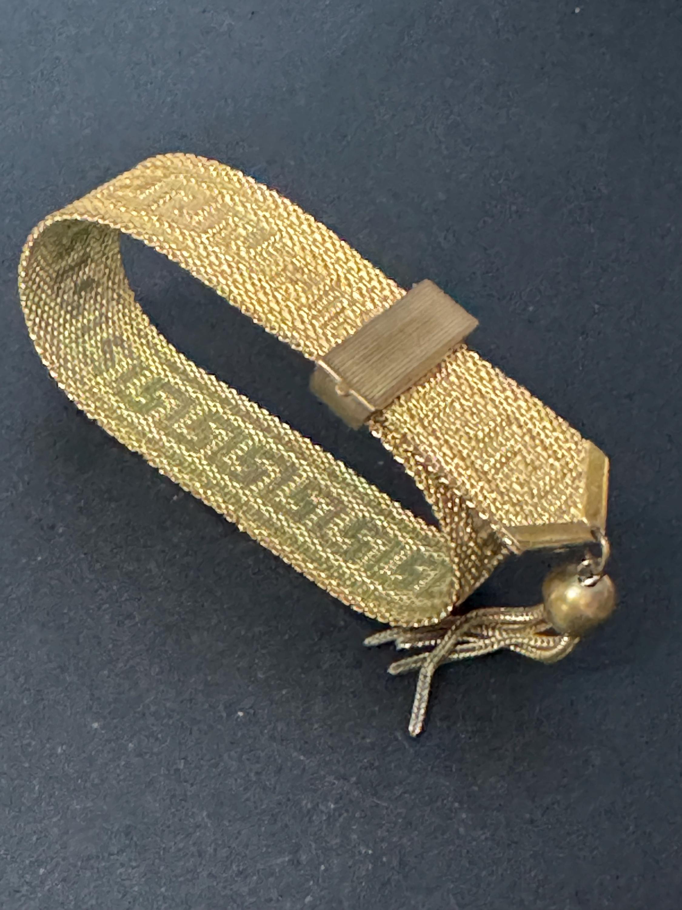 1970s Greek key design gold tone articulated flat 2cm wide tassel bracelet 19.5