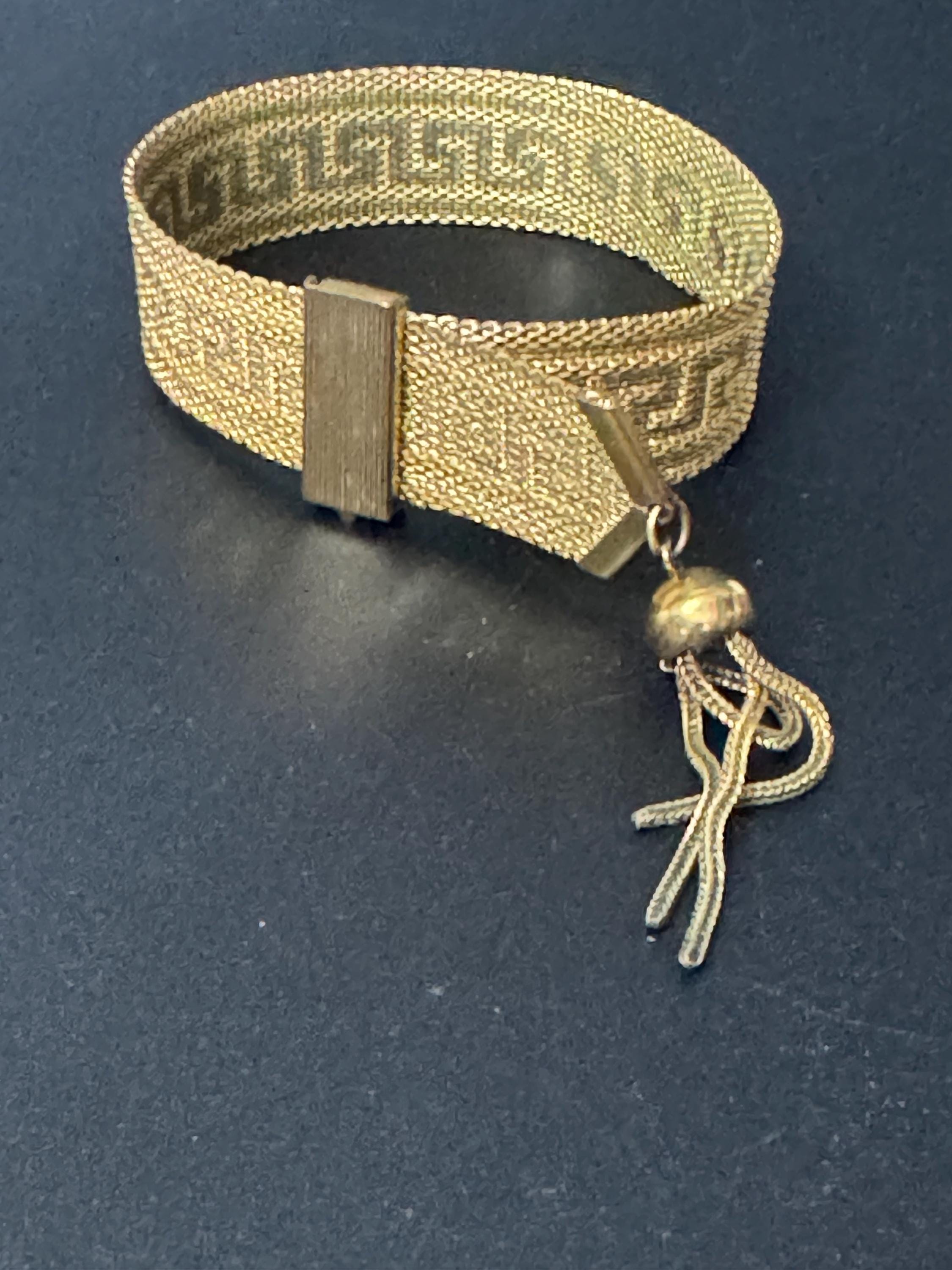 1970s Greek key design gold tone articulated flat 2cm wide tassel bracelet 19.5