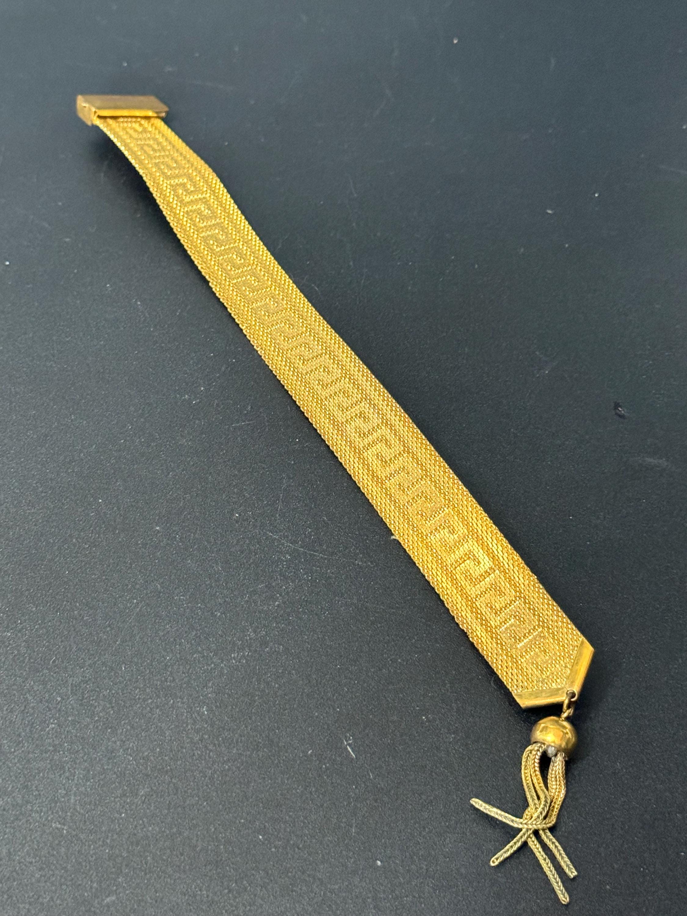 1970s Greek key design gold tone articulated flat 2cm wide tassel bracelet 19.5