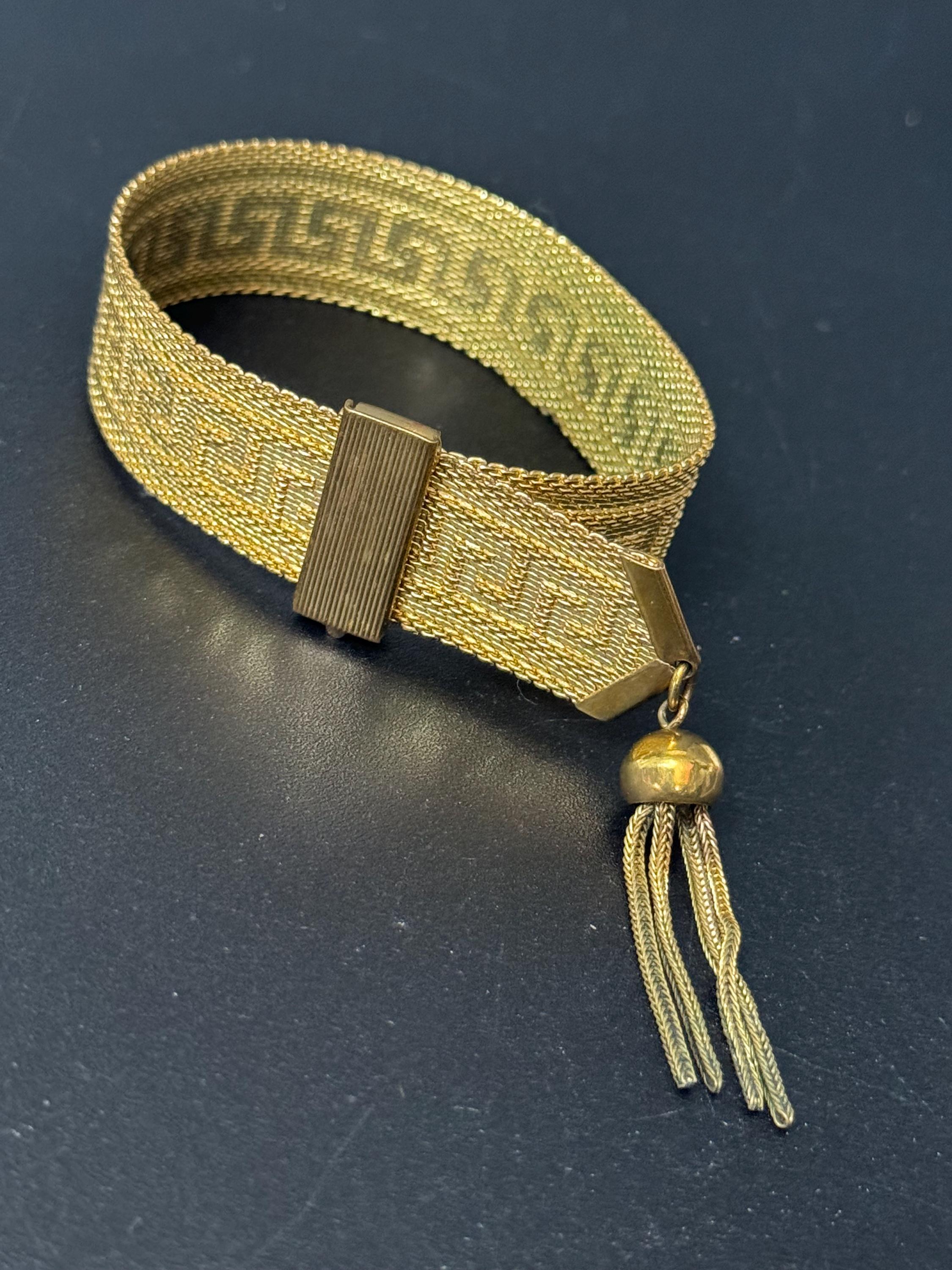 1970s Greek key design gold tone articulated flat 2cm wide tassel bracelet 19.5