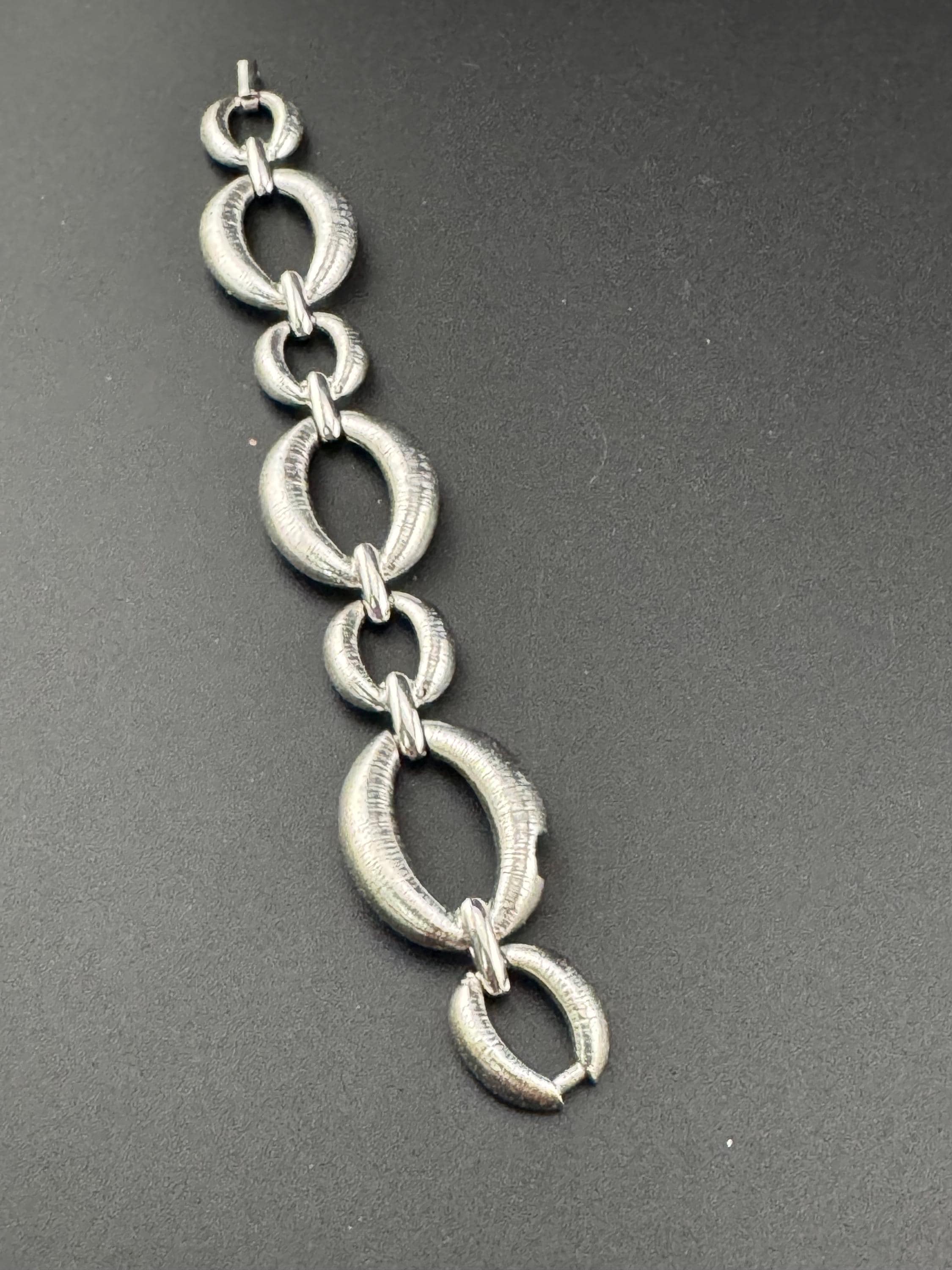 True vintage silver tone textured panel link bracelet and matching clip on drop earrings