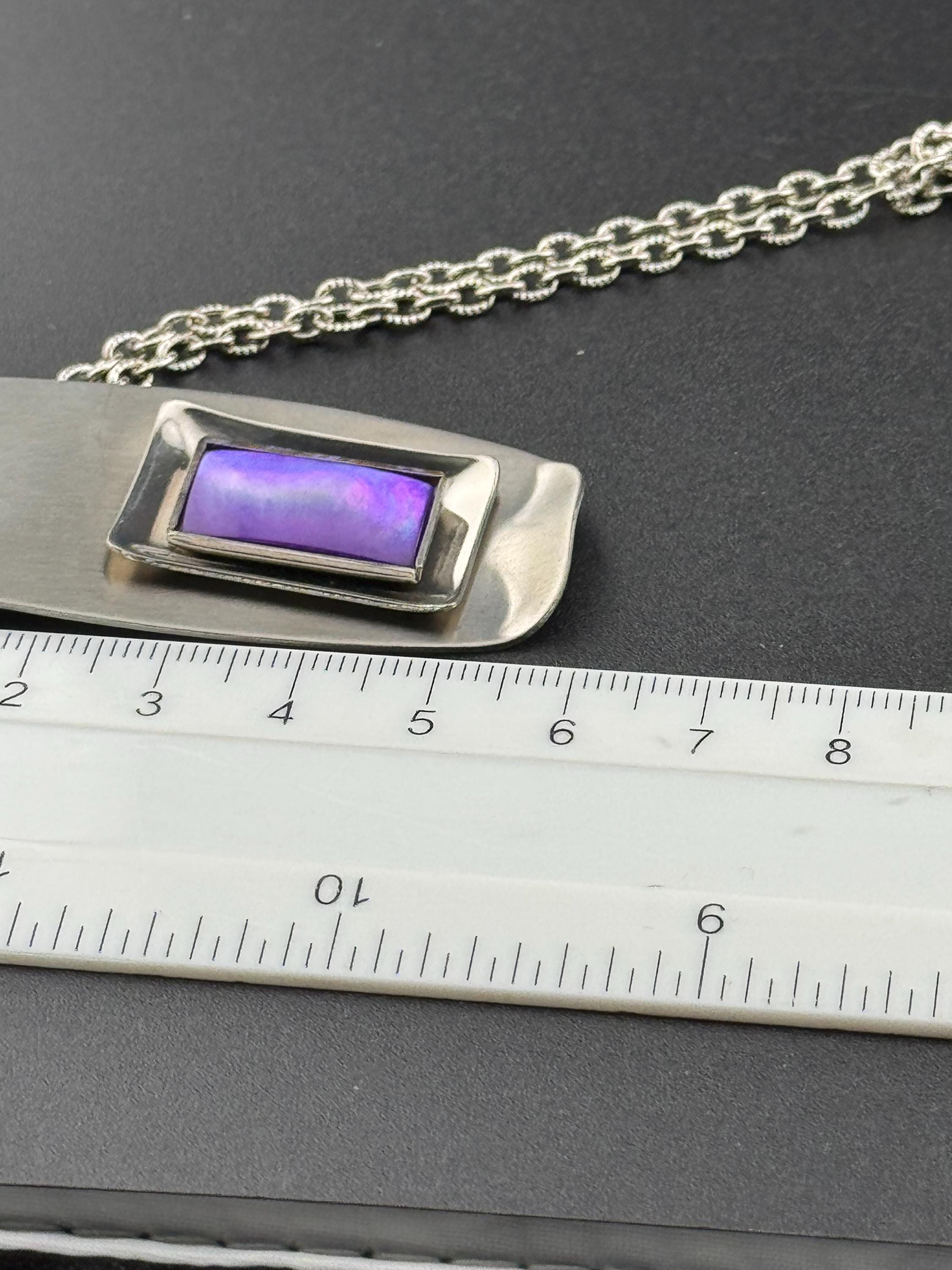 Signed Lord python Vintage Modernist silver tone stainless steel pendant necklace and chain set with central purple glass cabochon 1970s