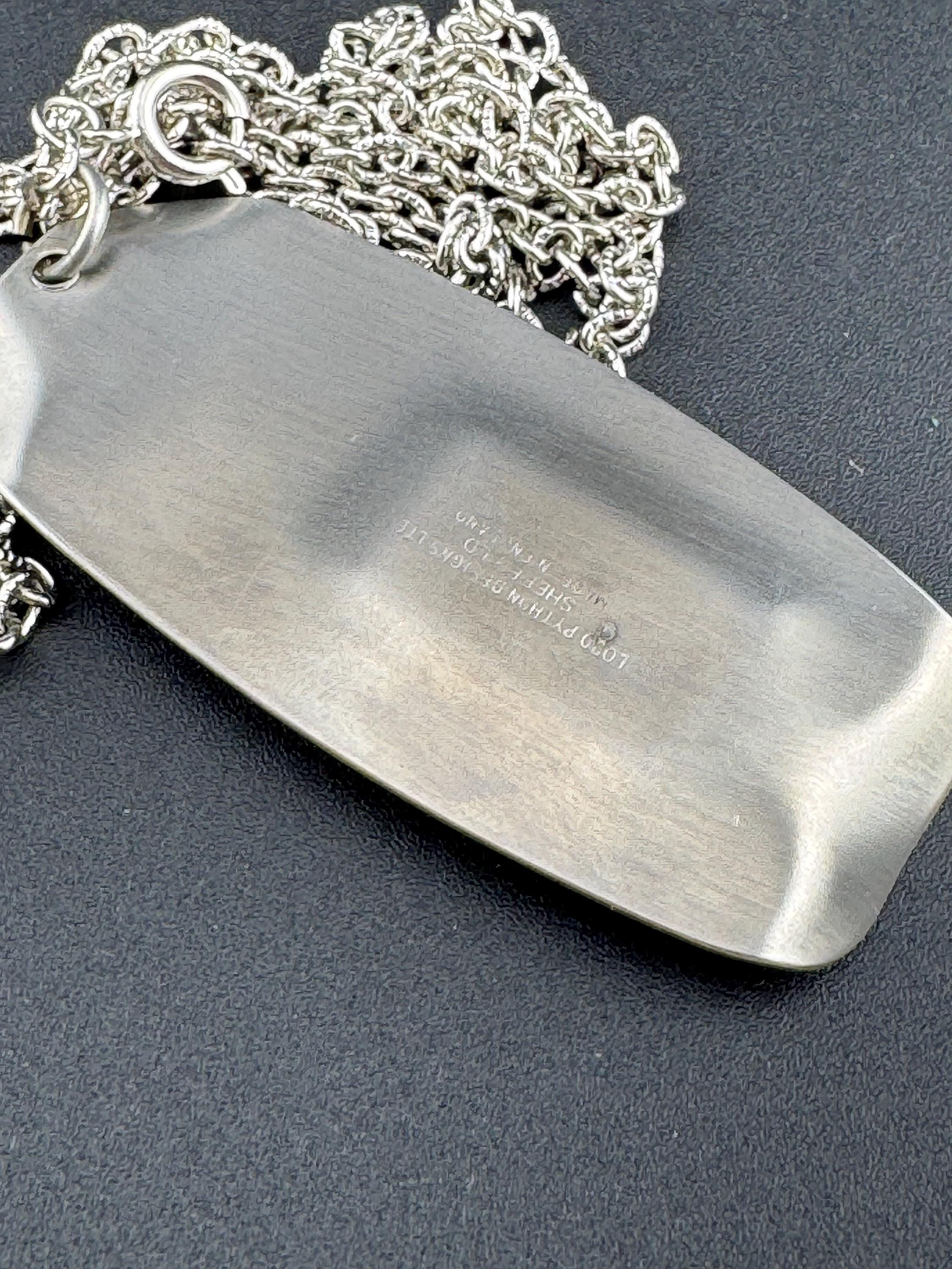 Signed Lord python Vintage Modernist silver tone stainless steel pendant necklace and chain set with central purple glass cabochon 1970s