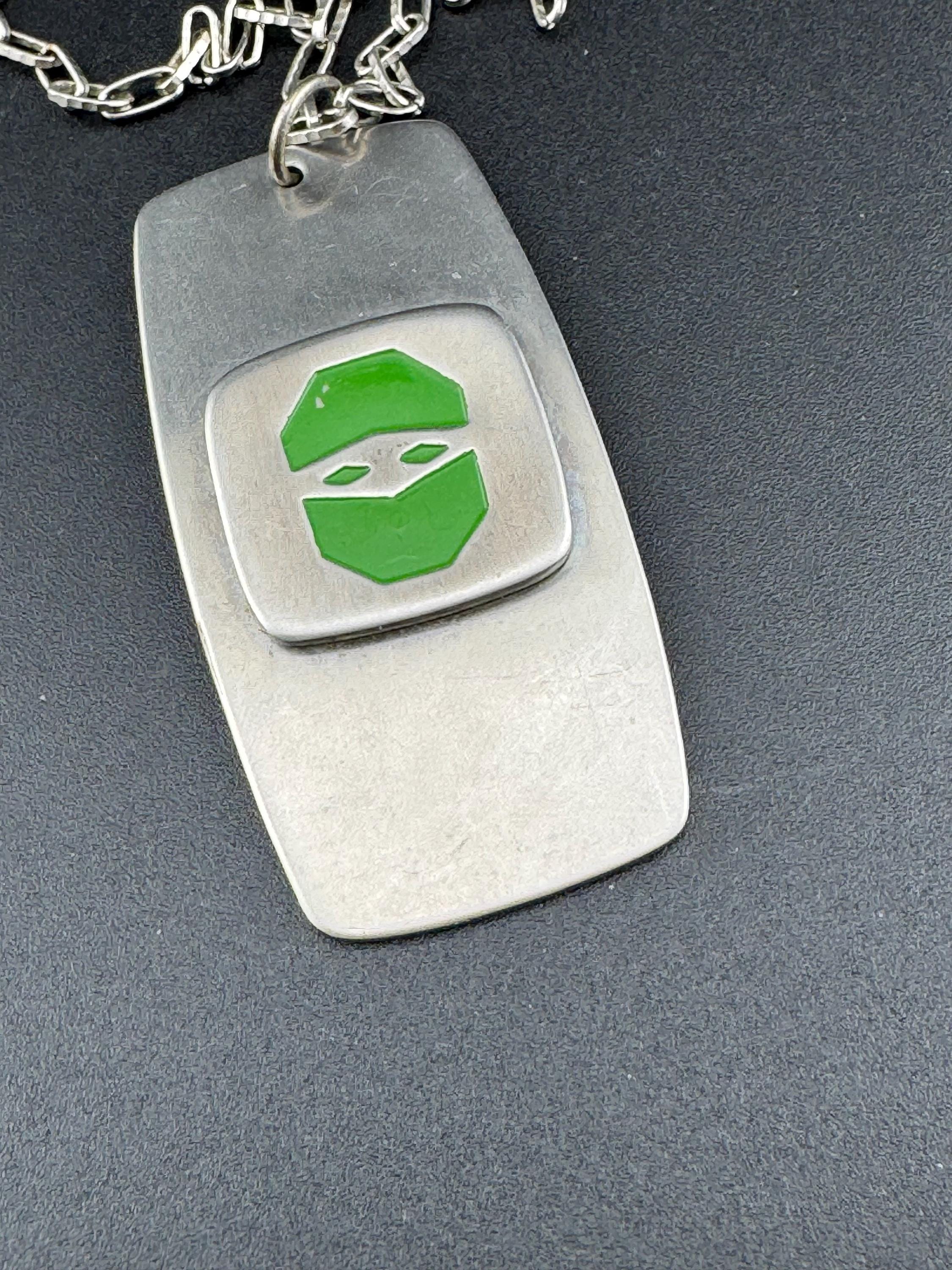 Vintage Modernist silver tone stainless steel pendant necklace and chain set with central bright green design 1970s