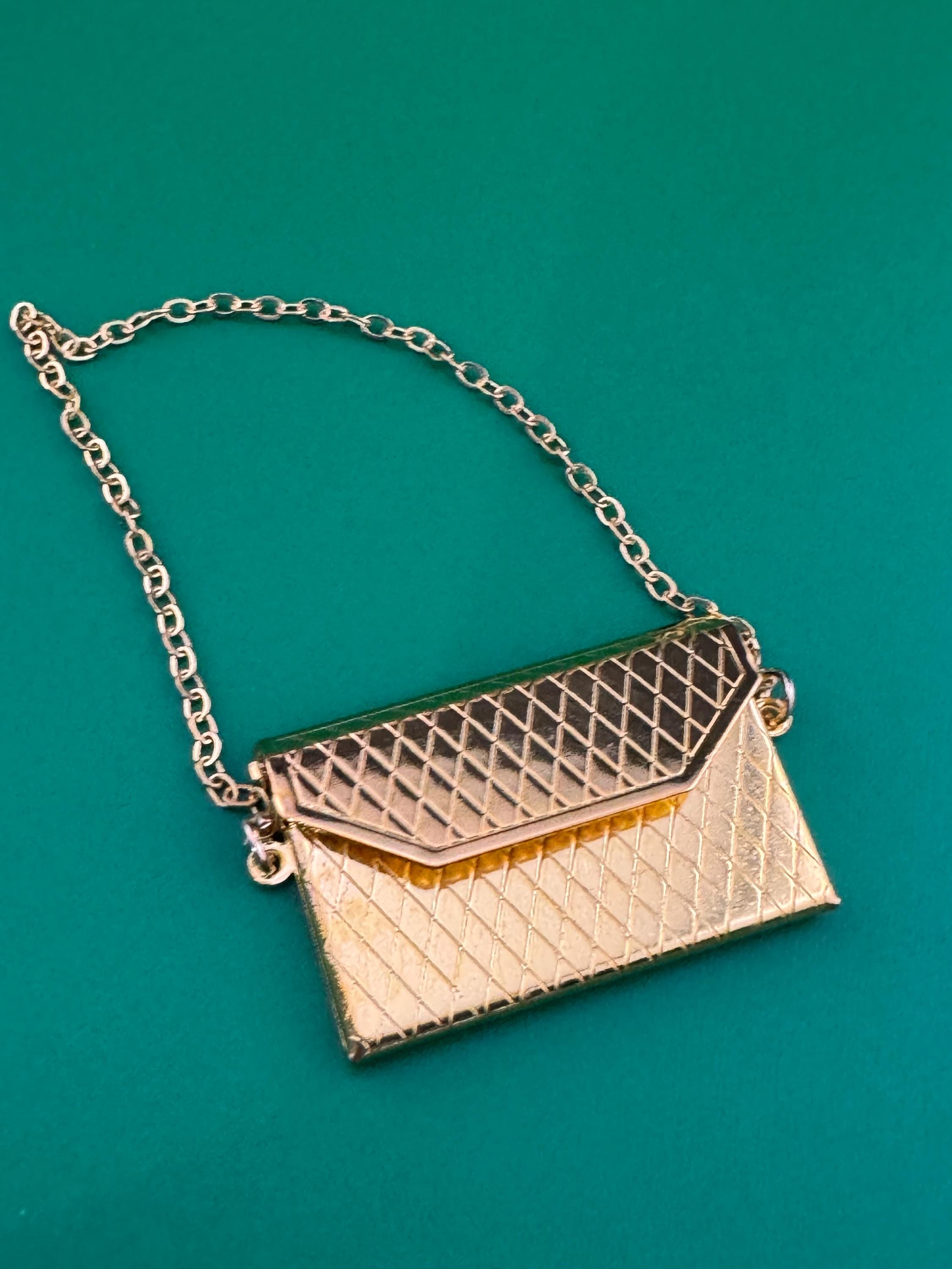 miniature gold clutch chain handbag cake topper decoration for a dolls cake