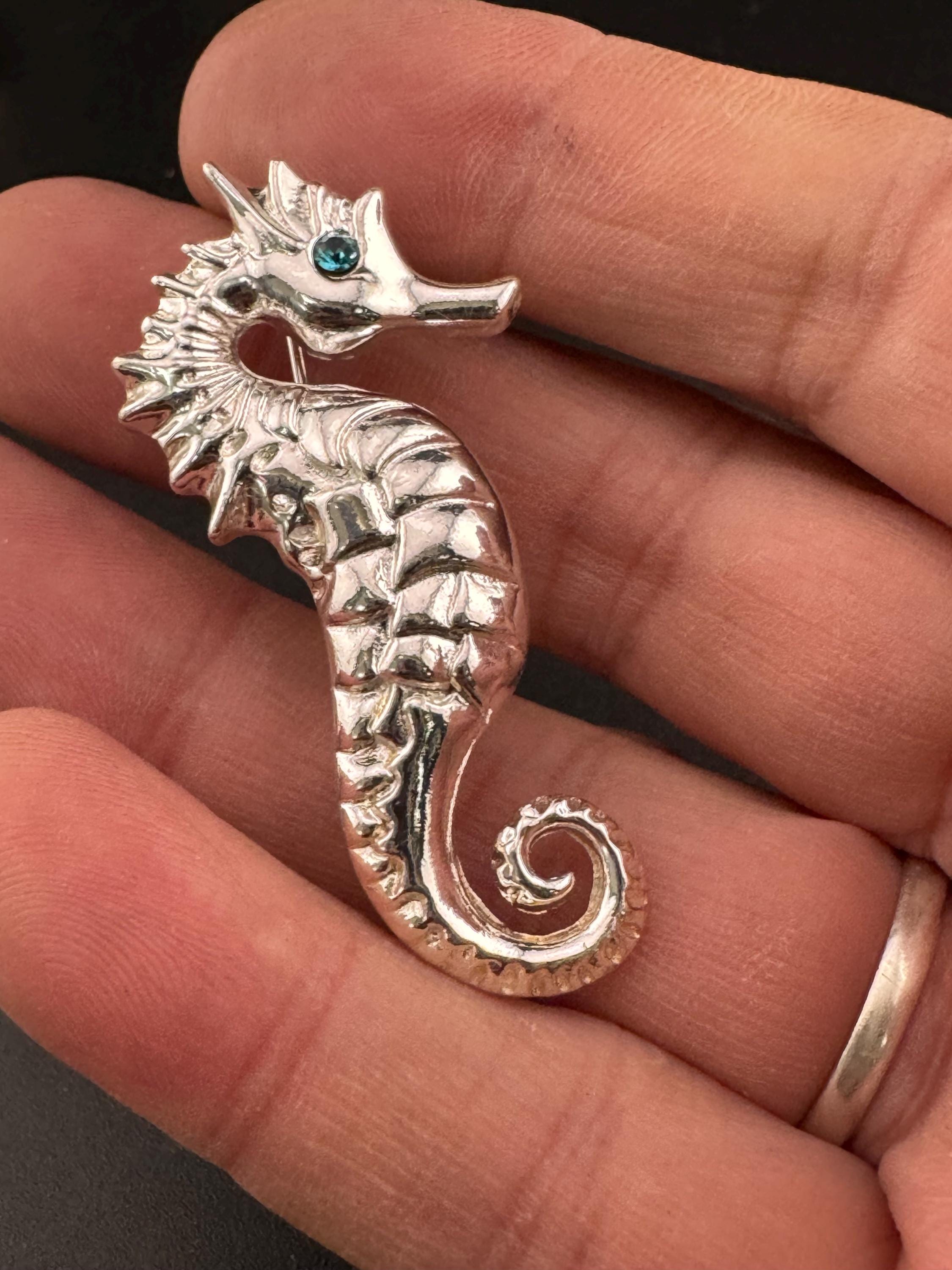 Vintage silver metal seahorse brooch with turquoise blue diamanté eye, nautical marine style