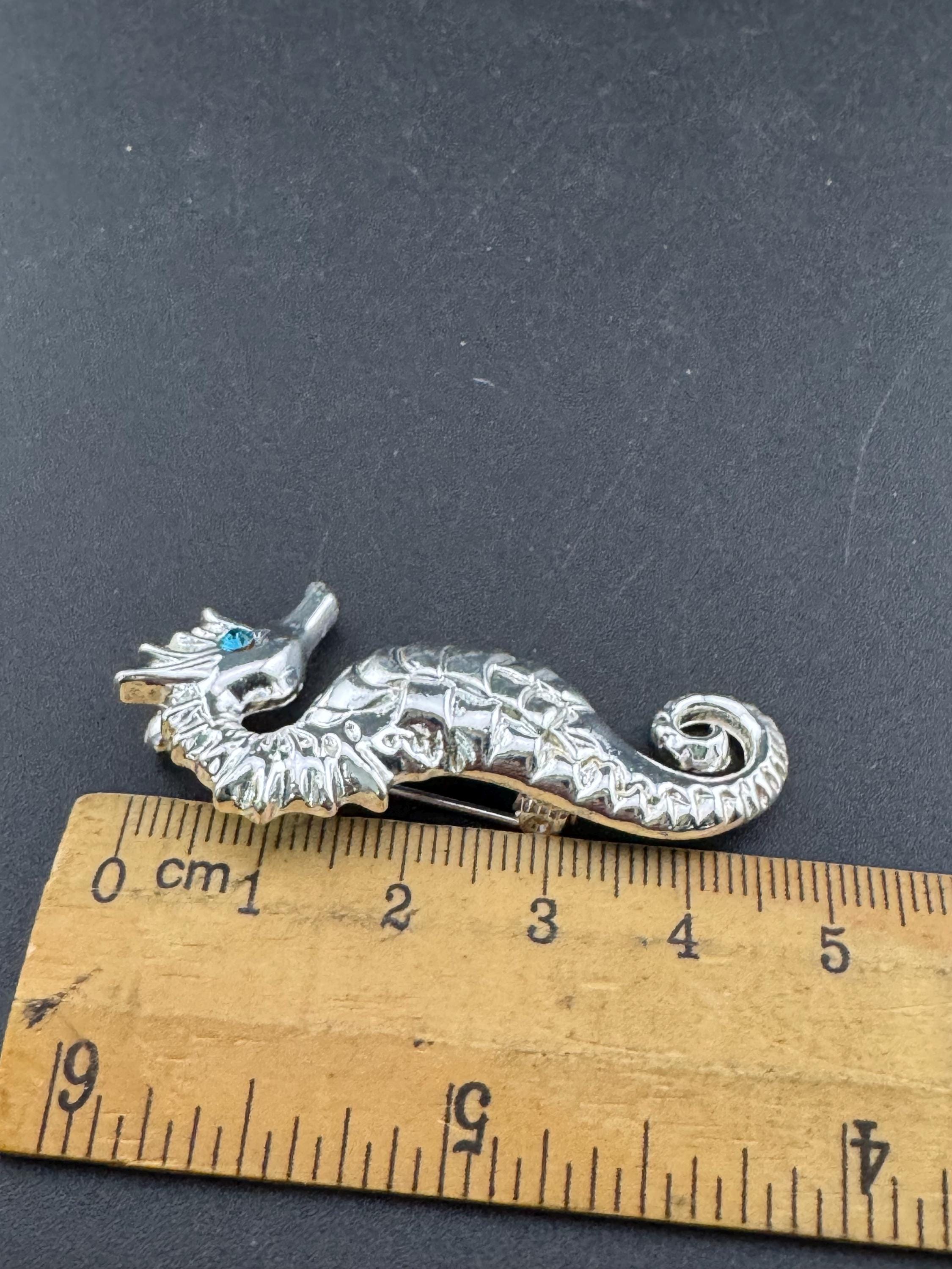 Vintage silver metal seahorse brooch with turquoise blue diamanté eye, nautical marine style