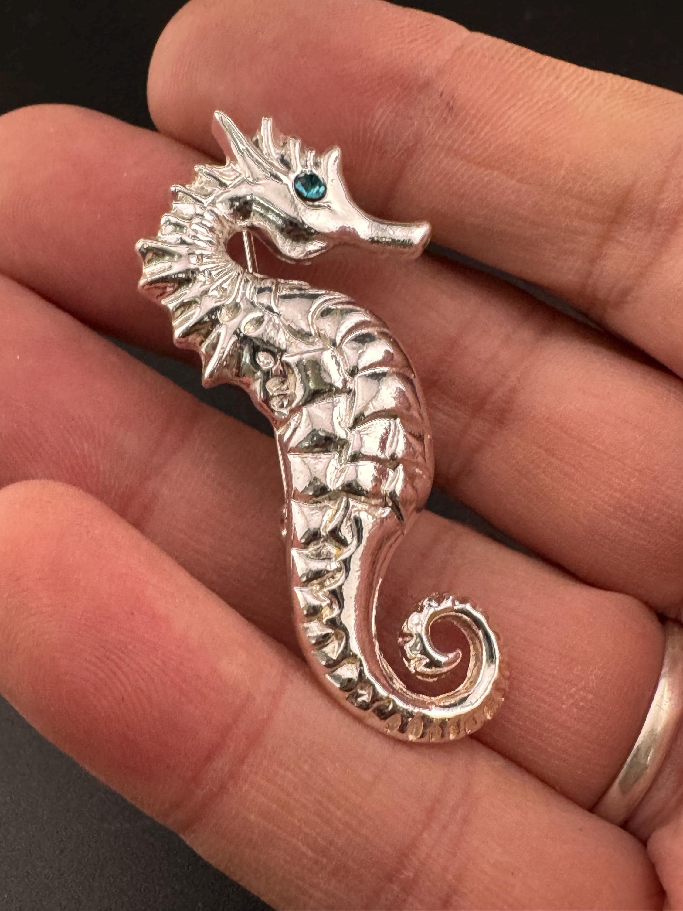 Vintage silver metal seahorse brooch with turquoise blue diamanté eye, nautical marine style