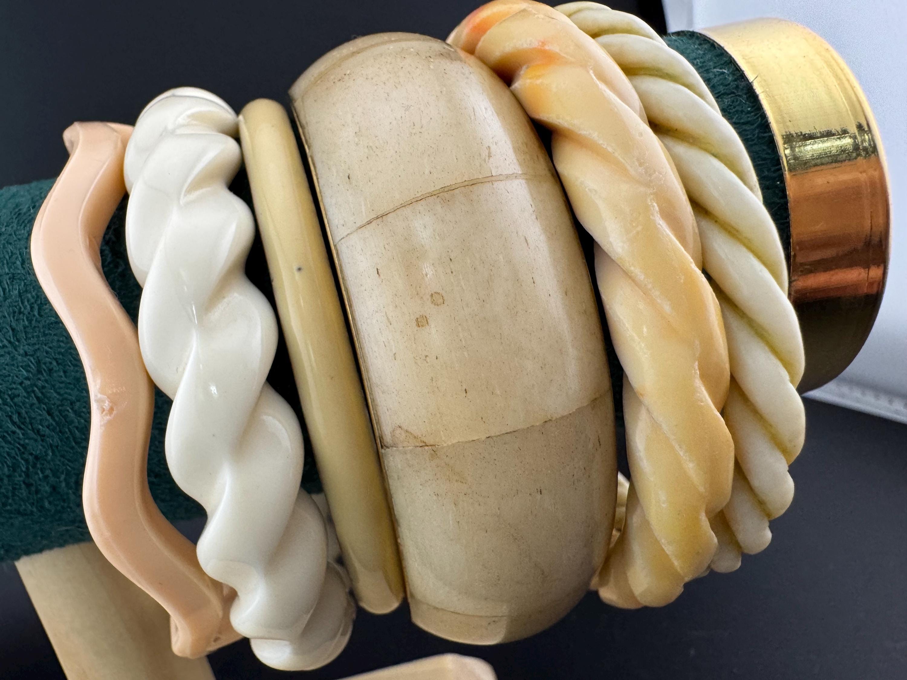A curated stack of Cream pink beige neutrals vintage and retro plastic bangles