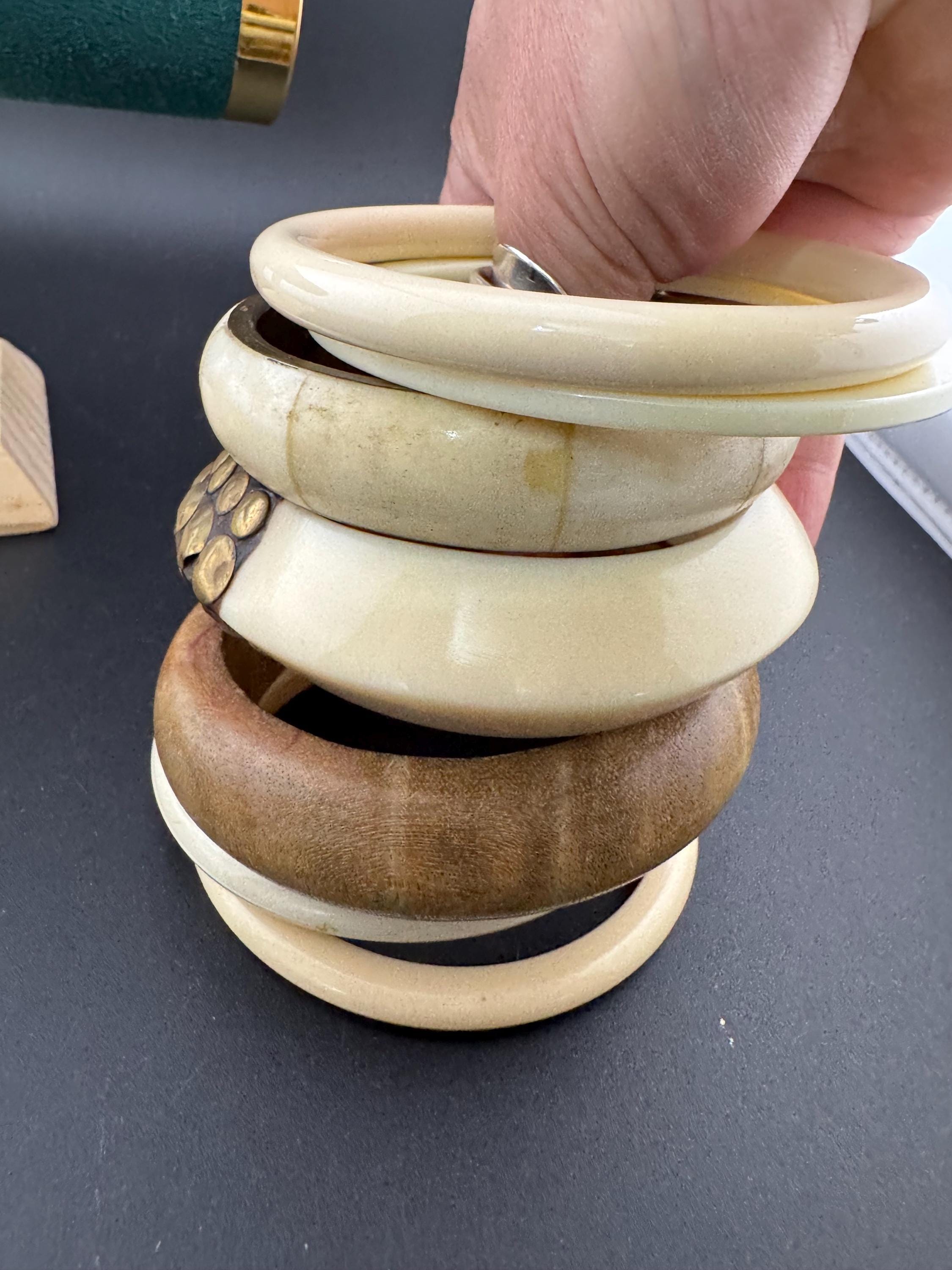 A curated stack of Cream brown beige neutrals vintage and retro plastic wooden bangles