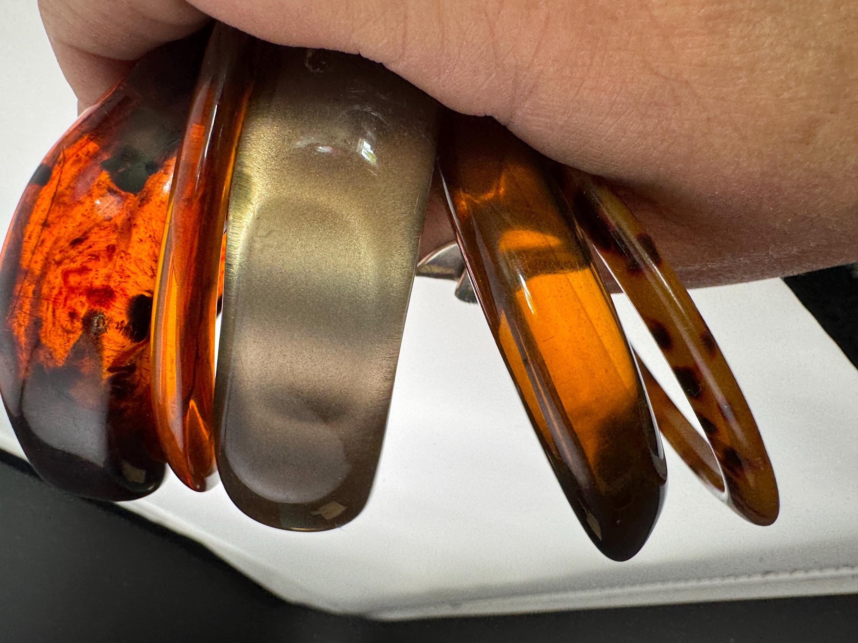 A curated stack of Faux tortoiseshell brown Perspex plastic wide cuff bangle bracelets ideal stacking layering Vintage