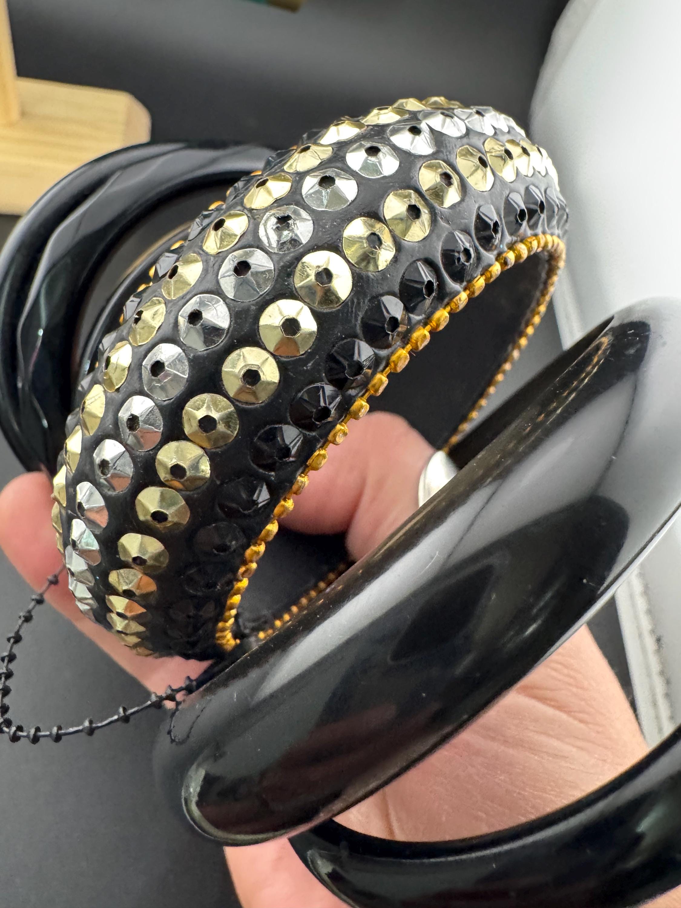 A curated set of vintage and retro gold black tones stacking bangles, boho festival bracelets