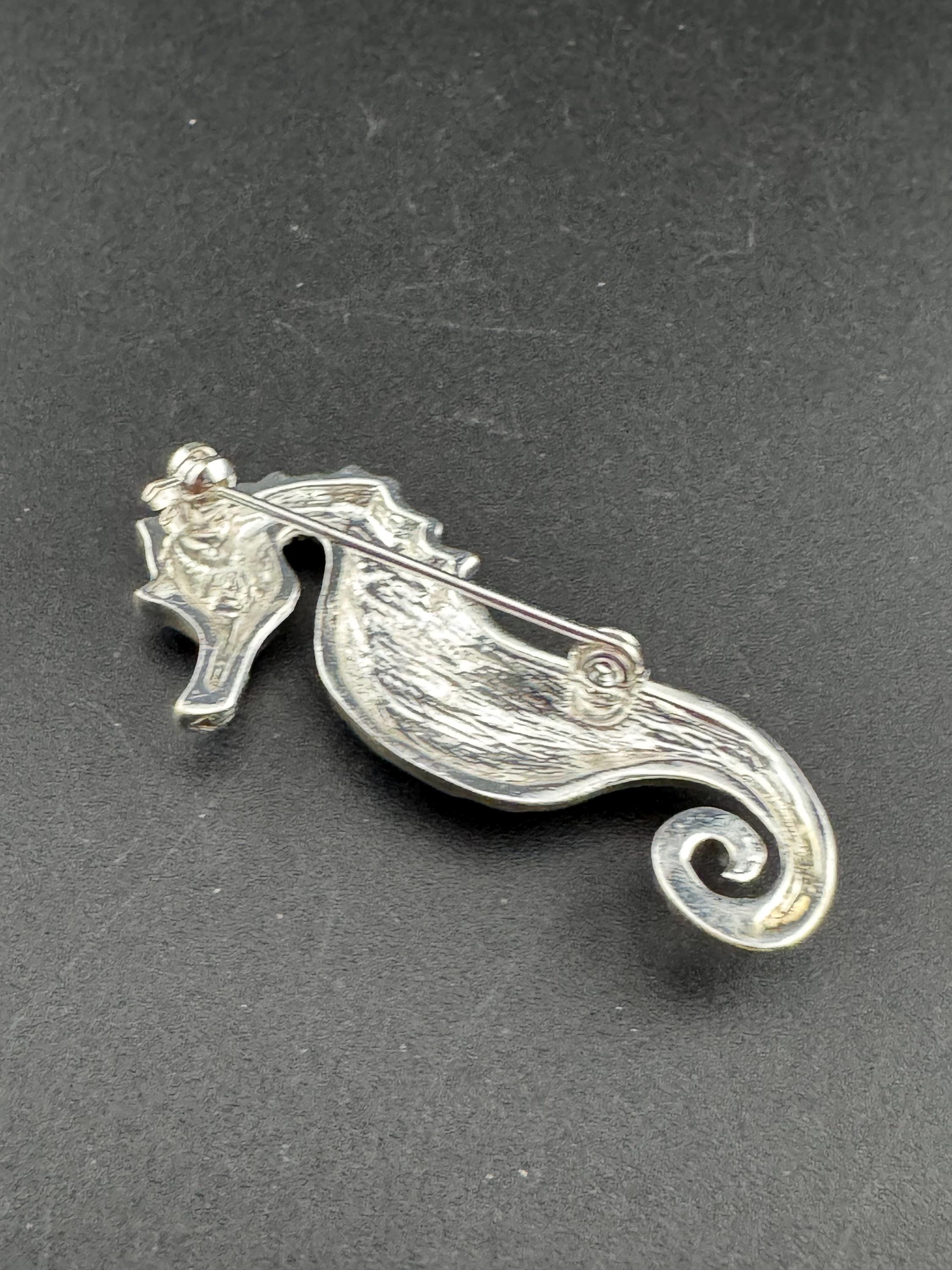 Vintage silver metal seahorse brooch with turquoise blue diamanté eye, nautical marine style