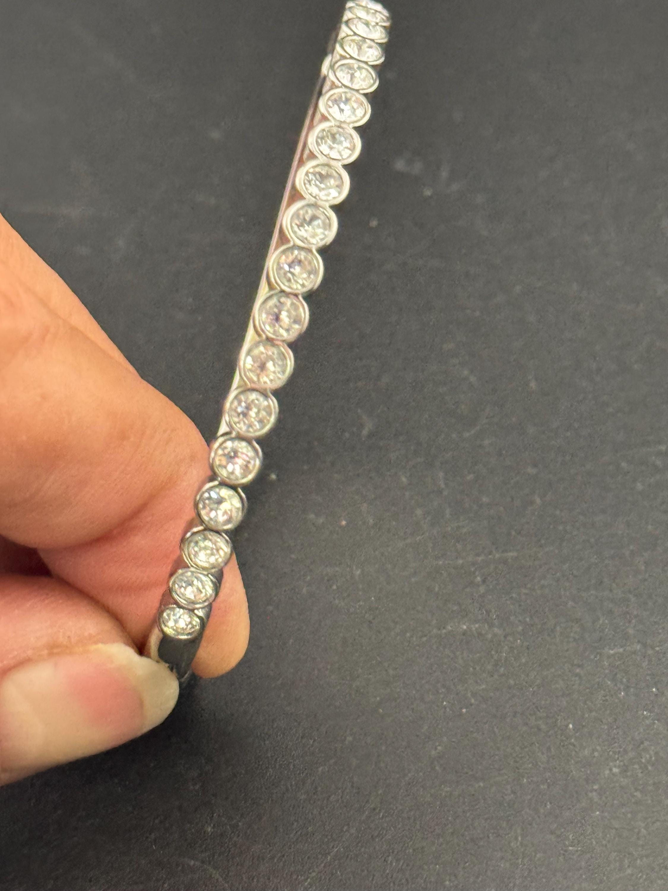Vintage slim silver tone hinged bangle bracelet with clear glass bezel set rhinestones crystals, signed