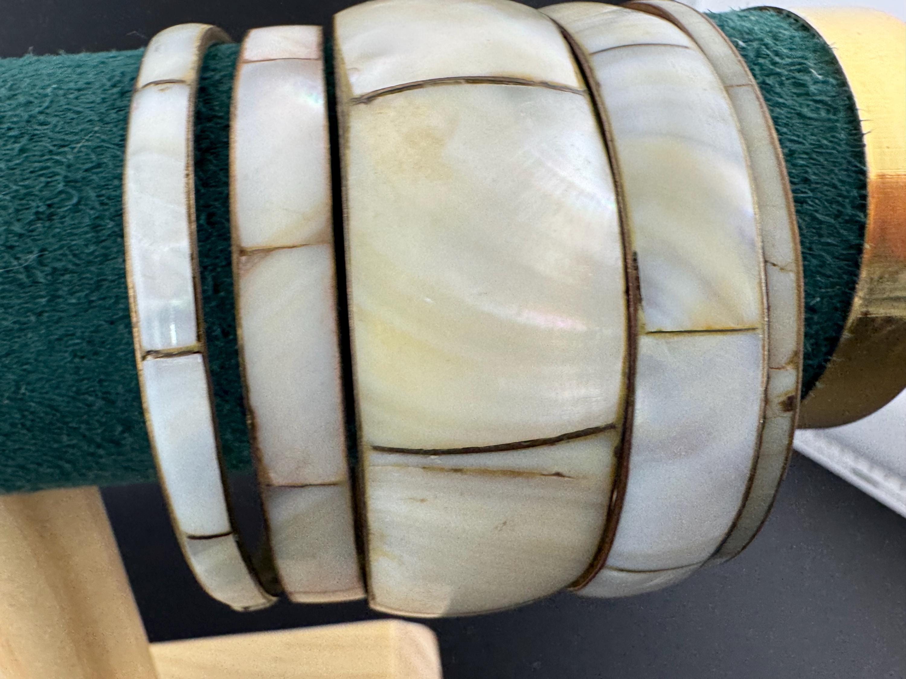 A curated set of vintage and retro gold tones mother of pearl stacking bangles, boho festival bracelets