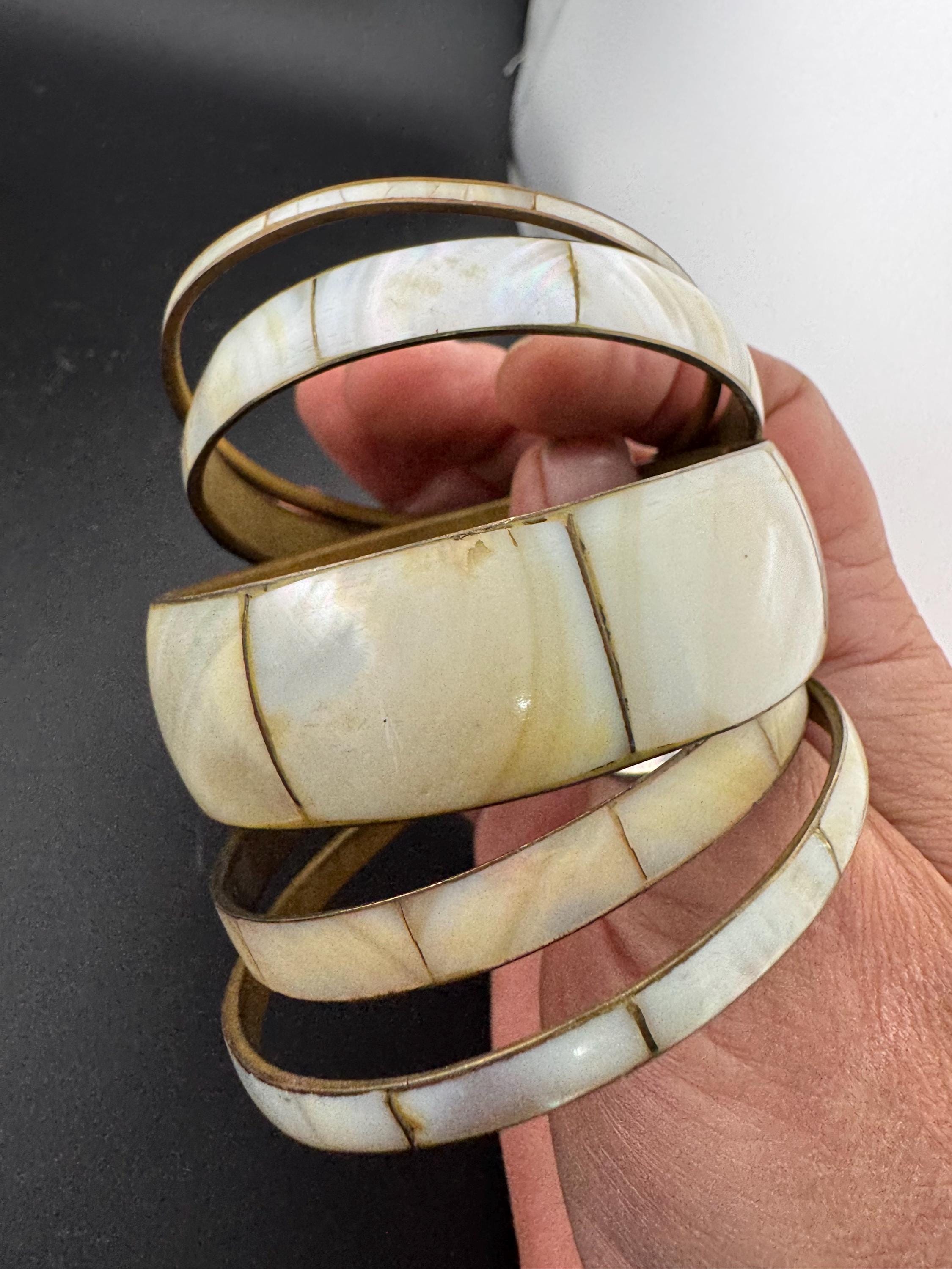 A curated set of vintage and retro gold tones mother of pearl stacking bangles, boho festival bracelets