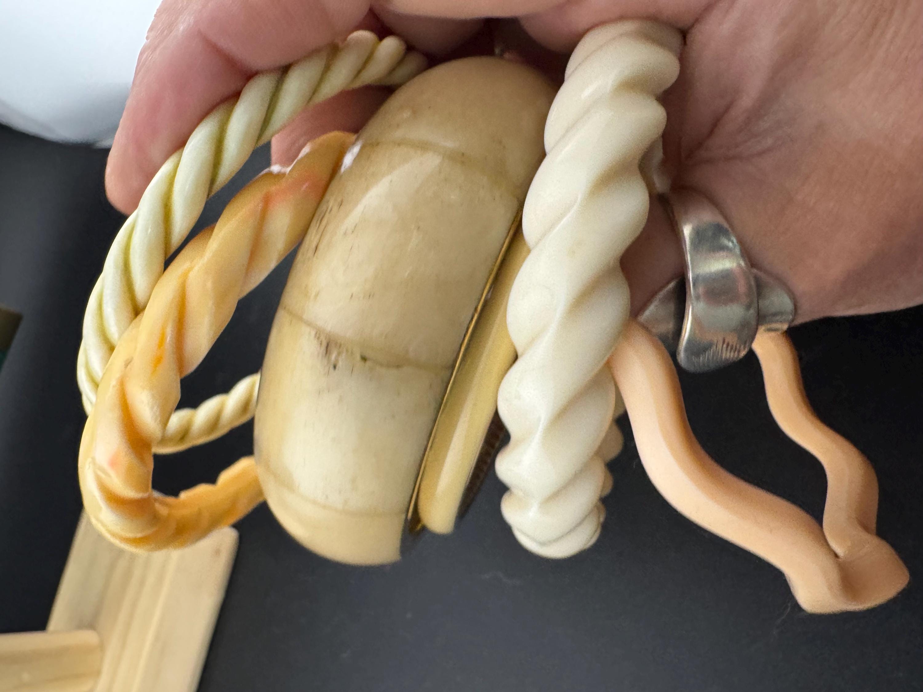 A curated stack of Cream pink beige neutrals vintage and retro plastic bangles