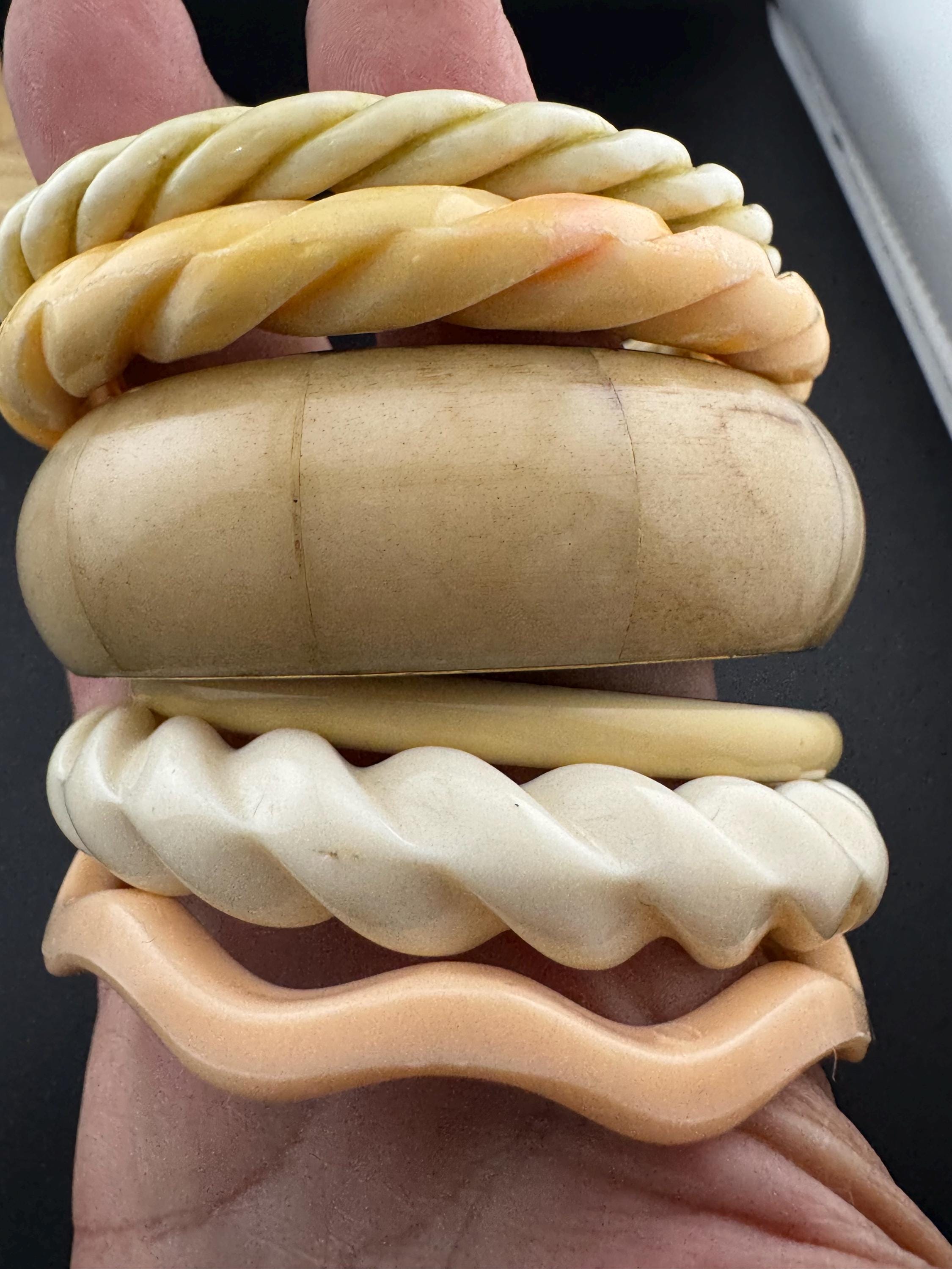 A curated stack of Cream pink beige neutrals vintage and retro plastic bangles