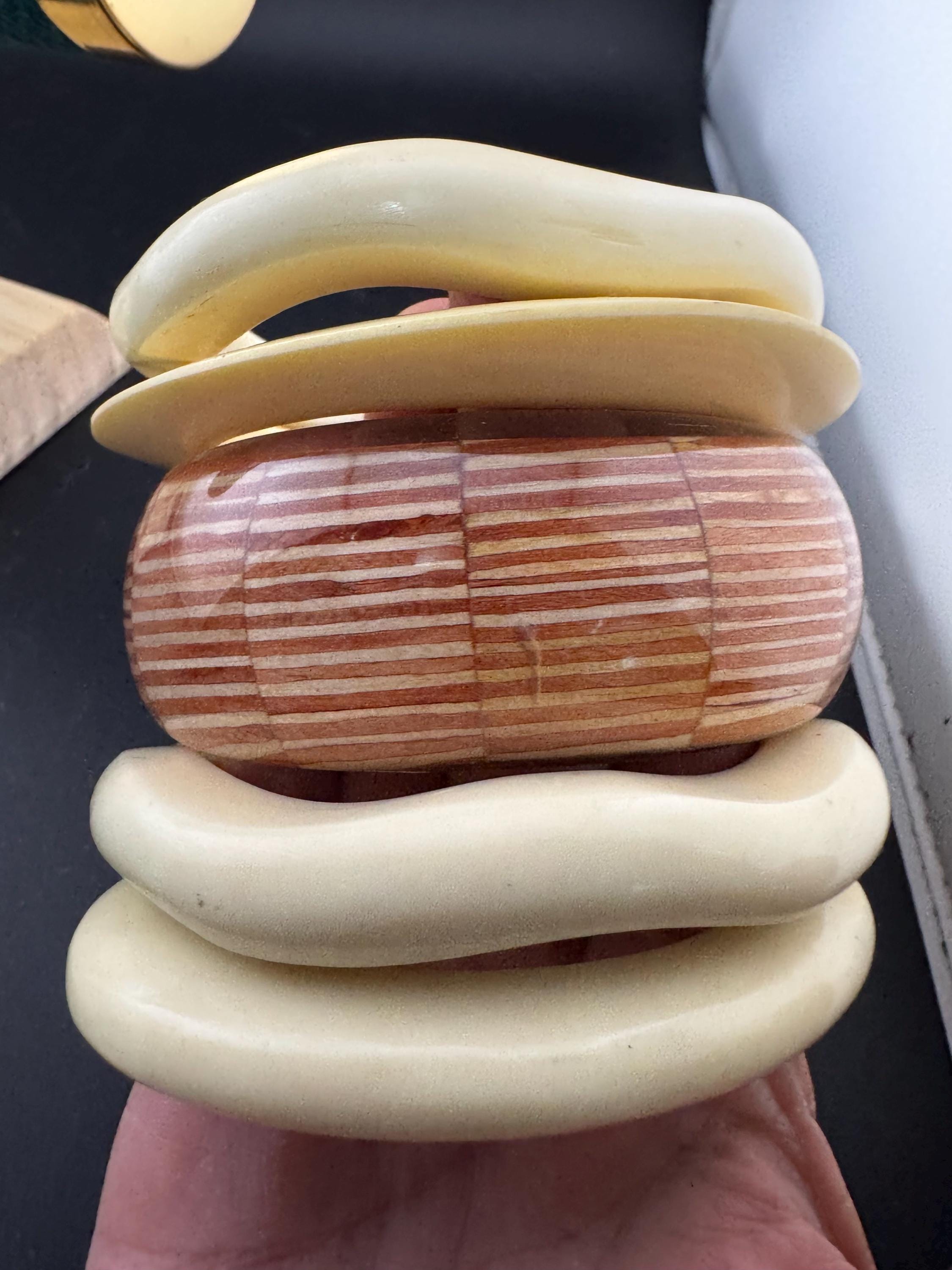 A curated stack of Cream brown beige neutrals vintage and retro plastic bangles