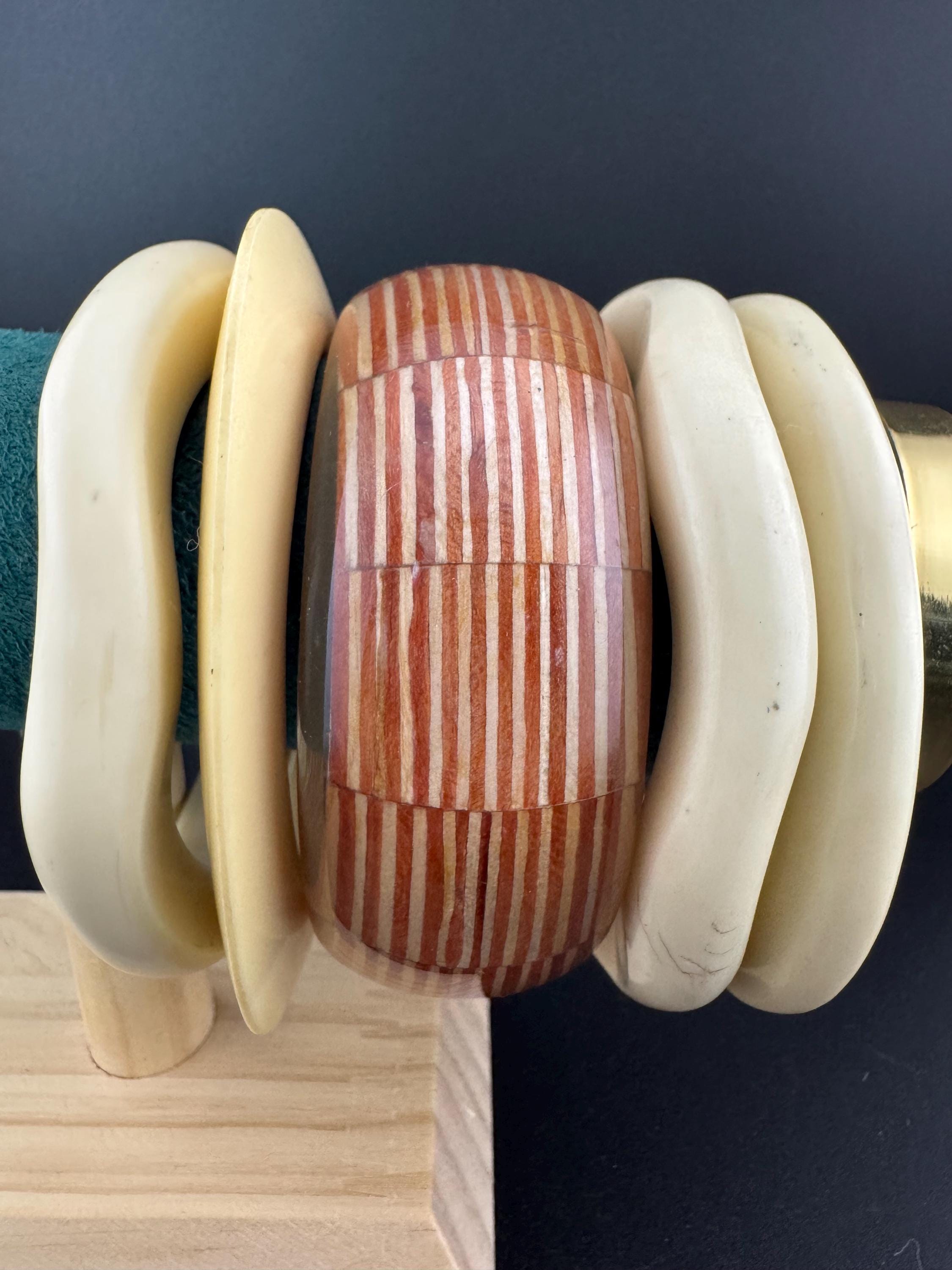 A curated stack of Cream brown beige neutrals vintage and retro plastic bangles