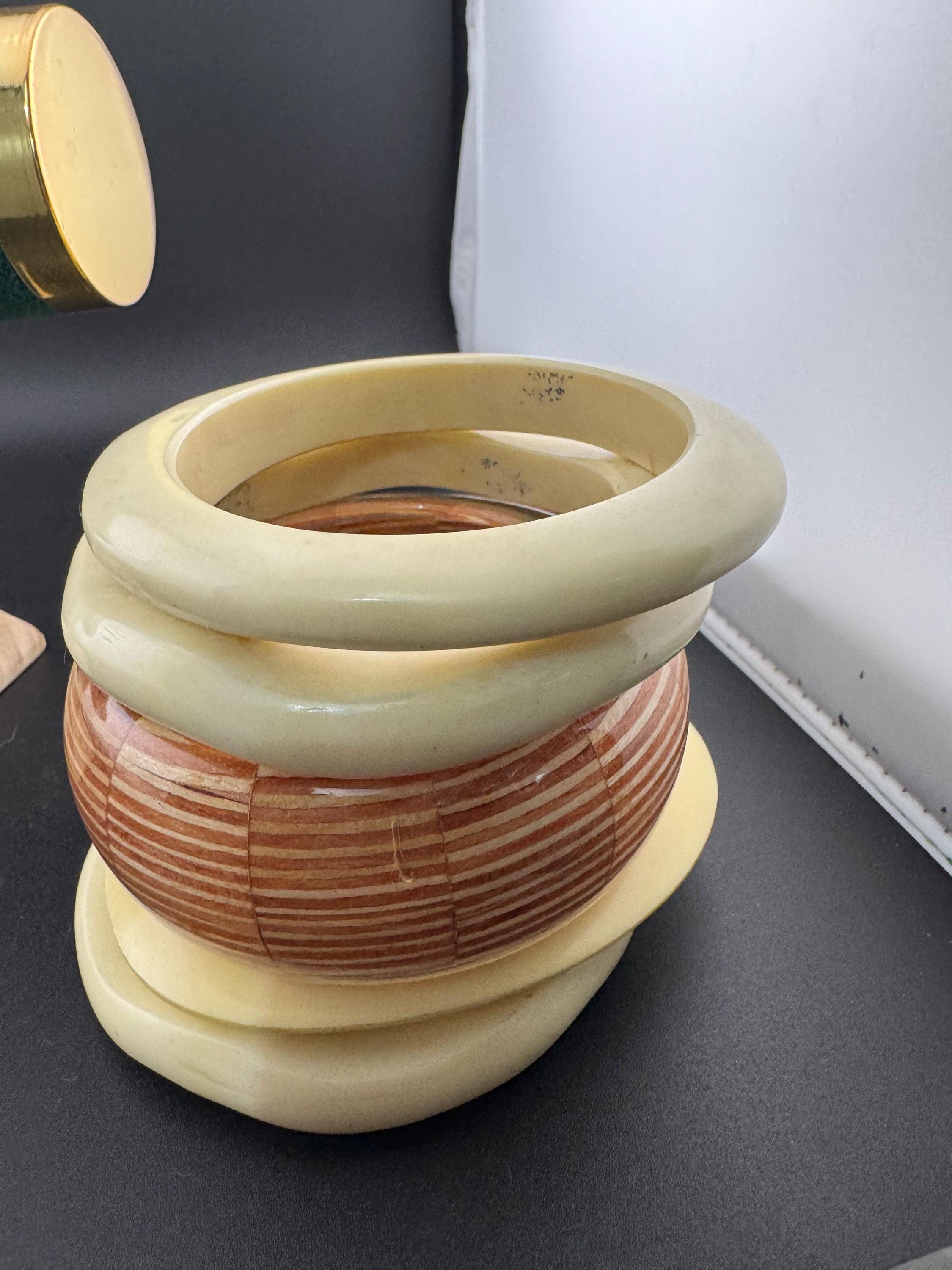 A curated stack of Cream brown beige neutrals vintage and retro plastic bangles