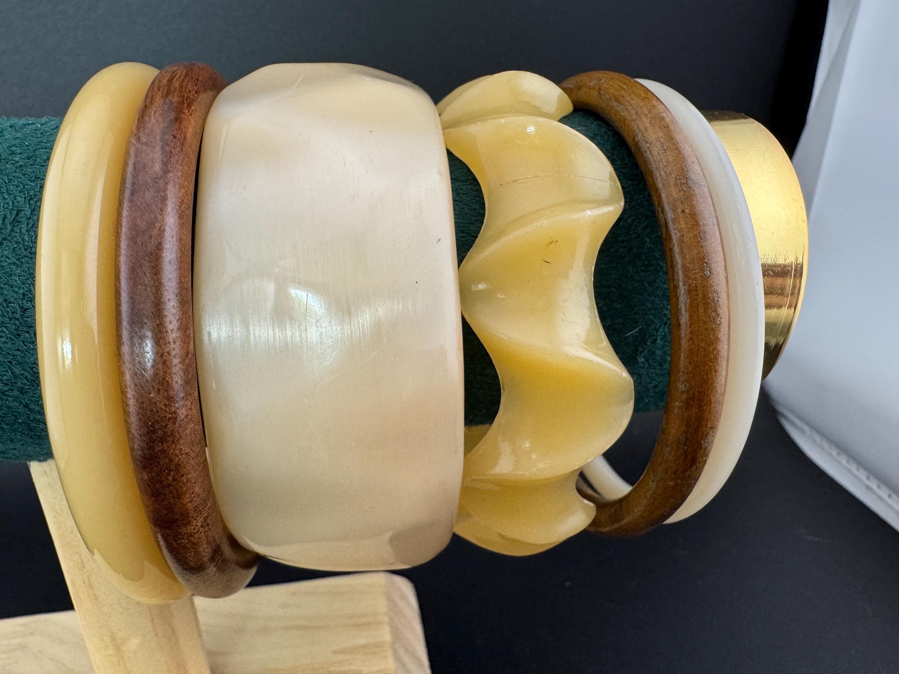 A curated stack of Cream brown beige neutrals vintage and retro plastic wooden bangles