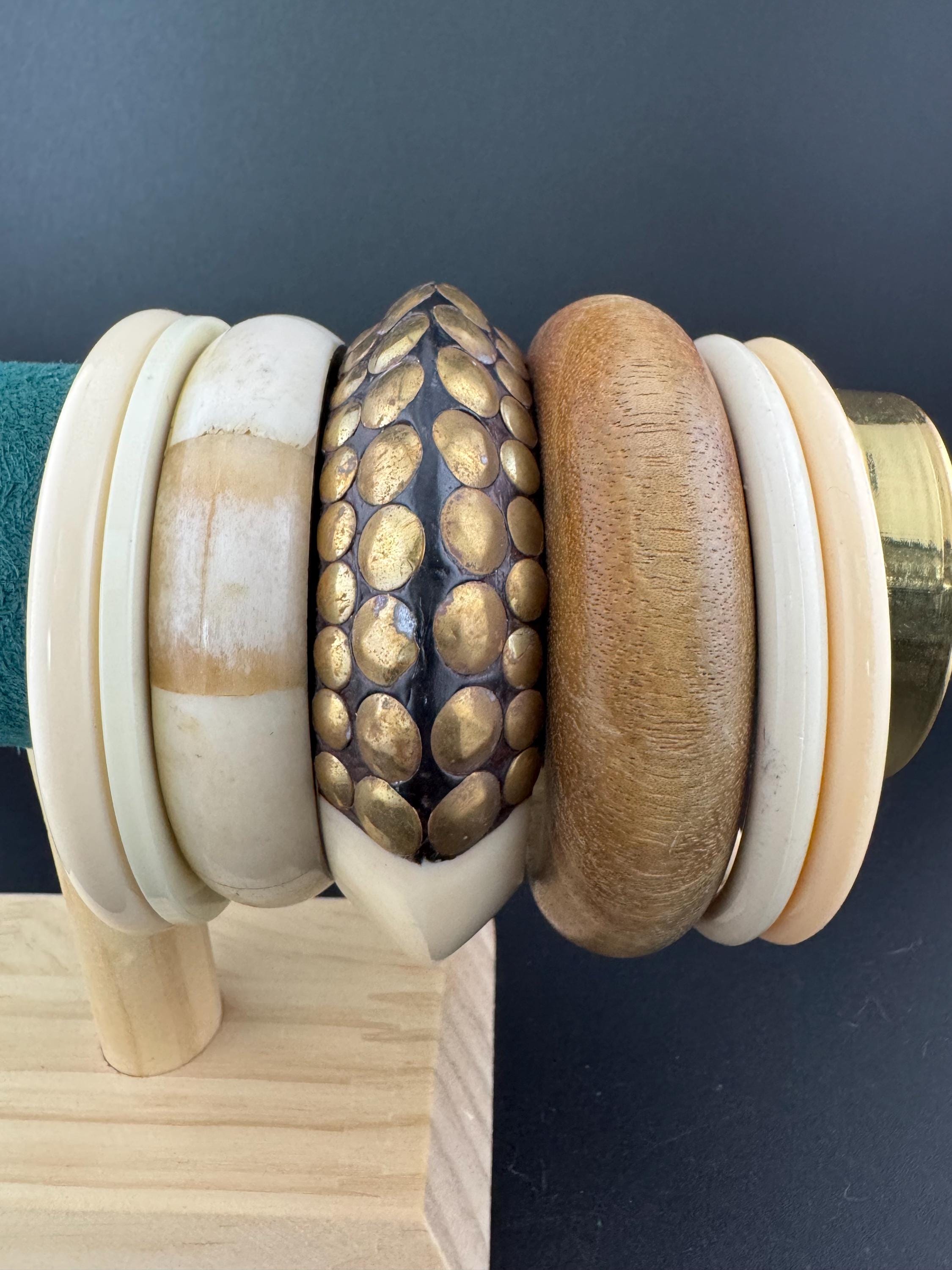 A curated stack of Cream brown beige neutrals vintage and retro plastic wooden bangles