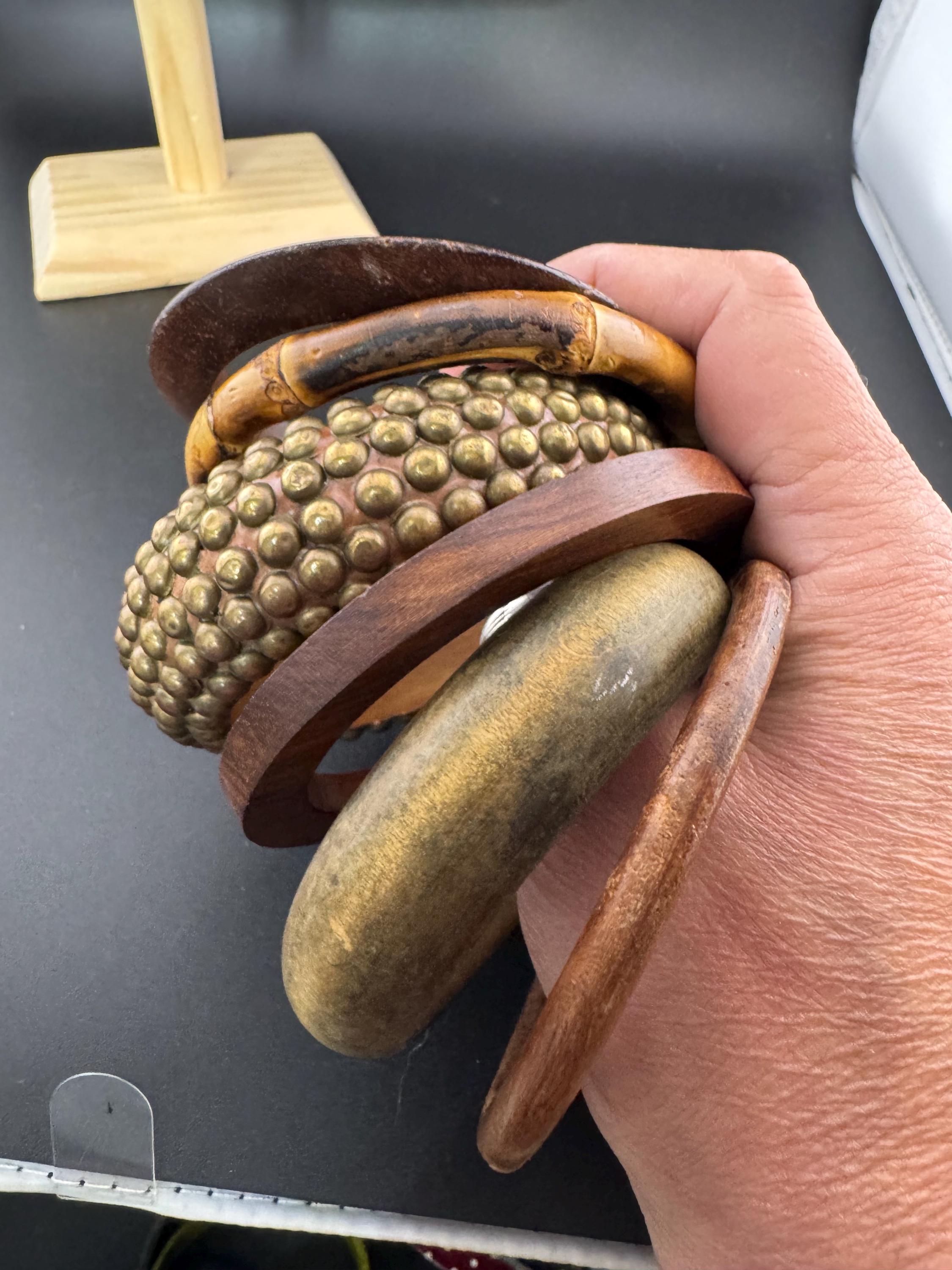 A curated stack of vintage retro wooden stacking bangles in brown natural shades ethnic tribal boho festival bracelets