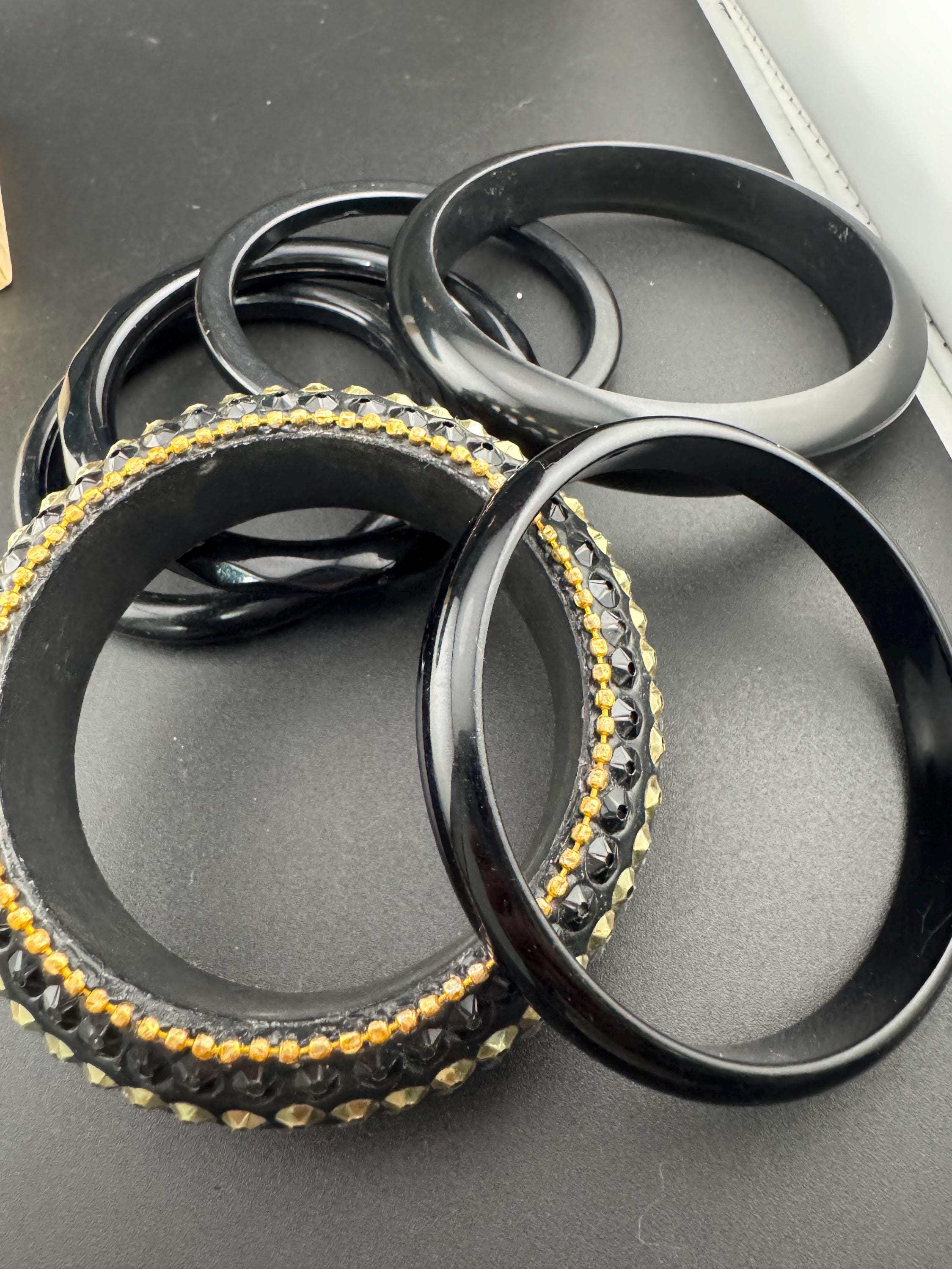 A curated set of vintage and retro gold black tones stacking bangles, boho festival bracelets
