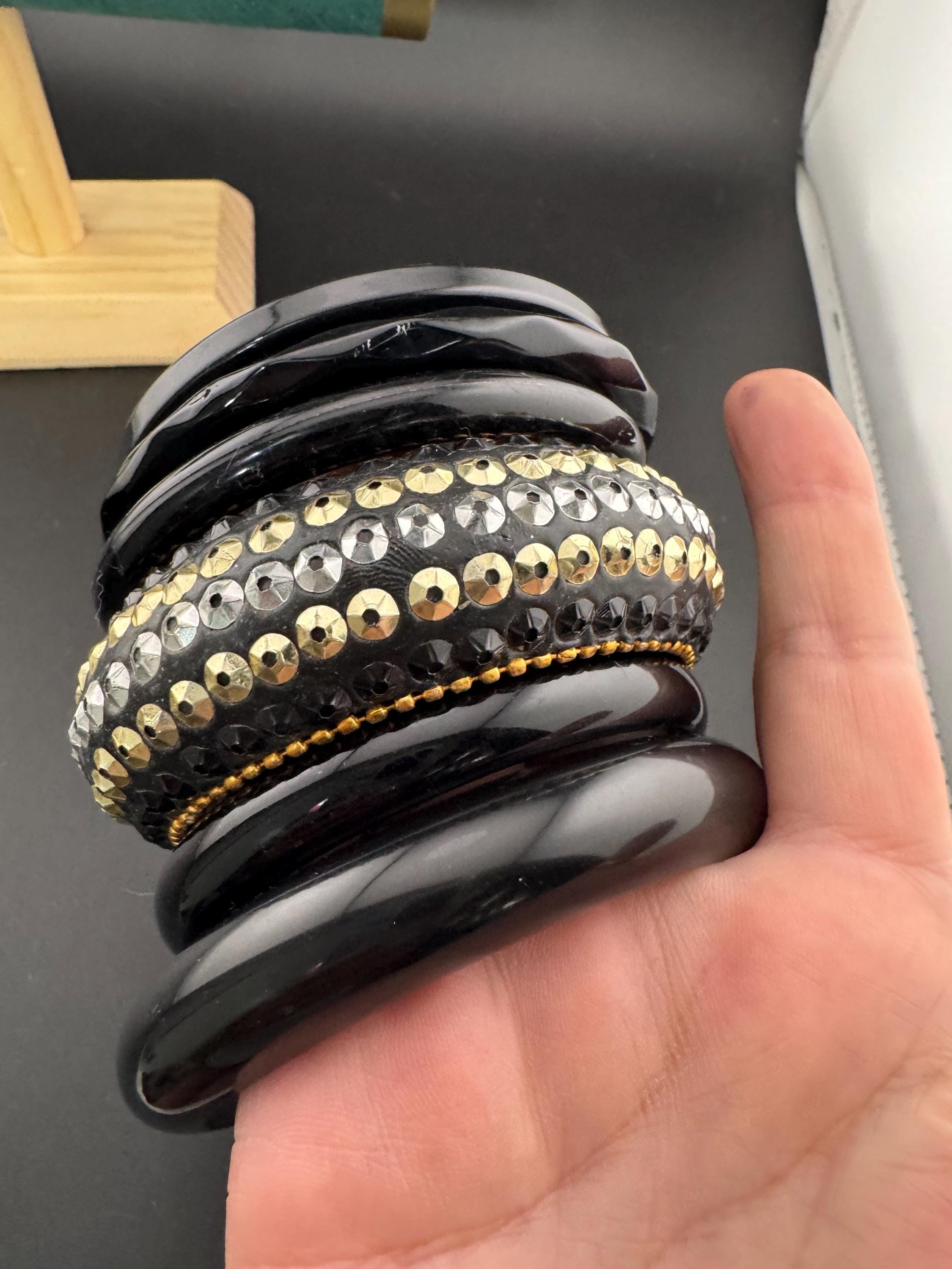 A curated set of vintage and retro gold black tones stacking bangles, boho festival bracelets