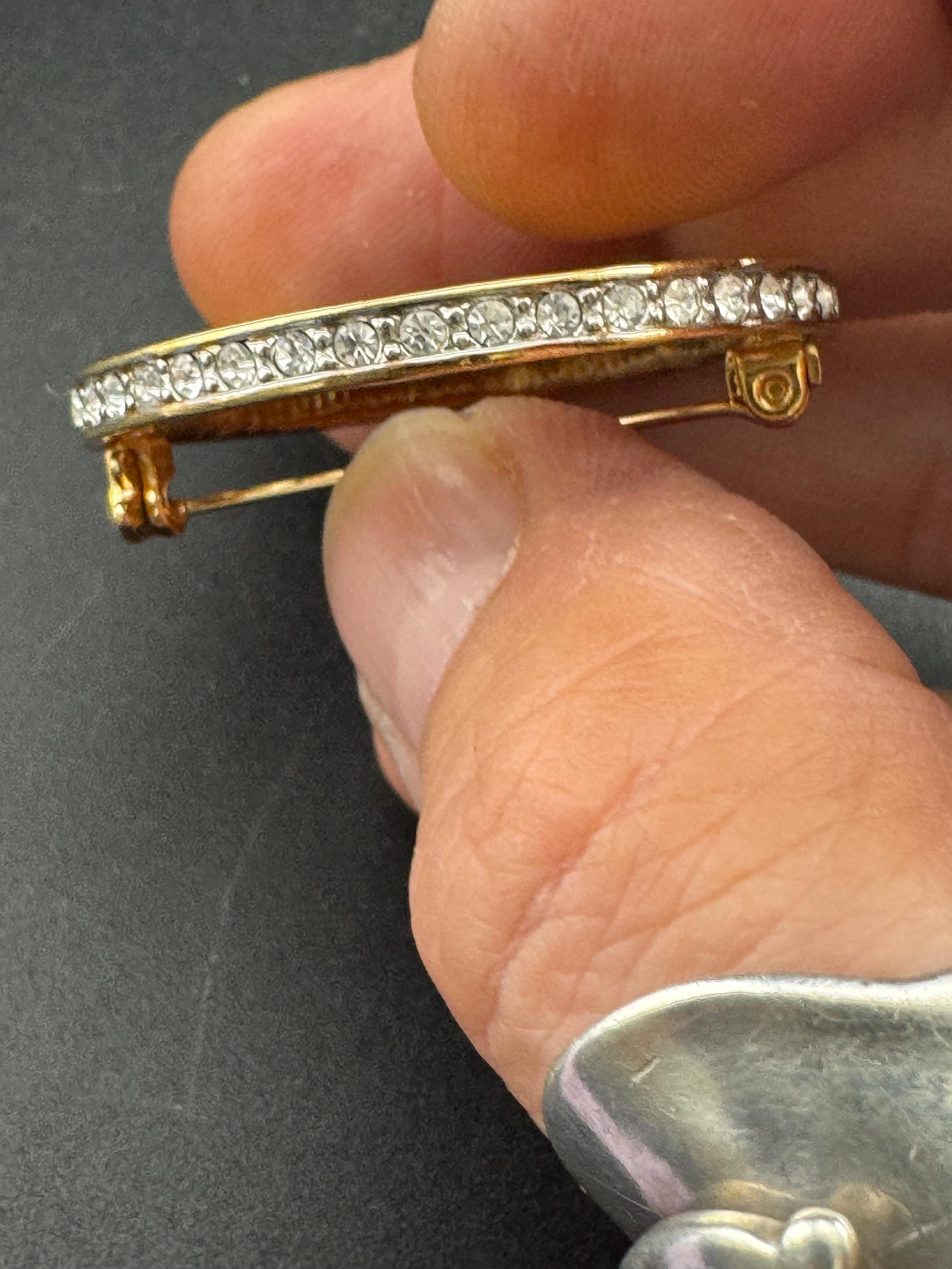 Vintage round openwork gold tone brooch channel set with clear rhinestones , sleek modernist design