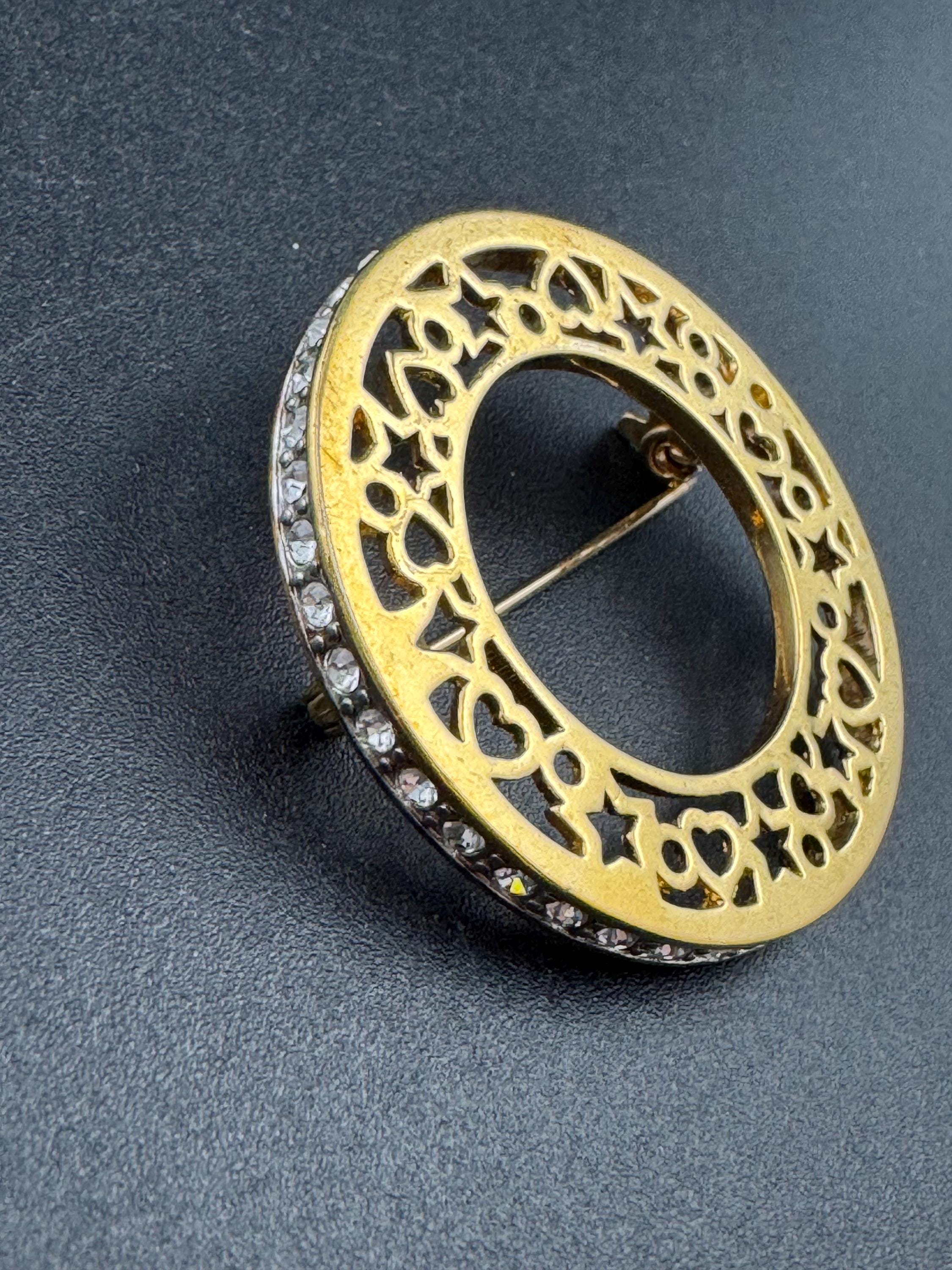 Vintage round openwork gold tone brooch channel set with clear rhinestones , sleek modernist design
