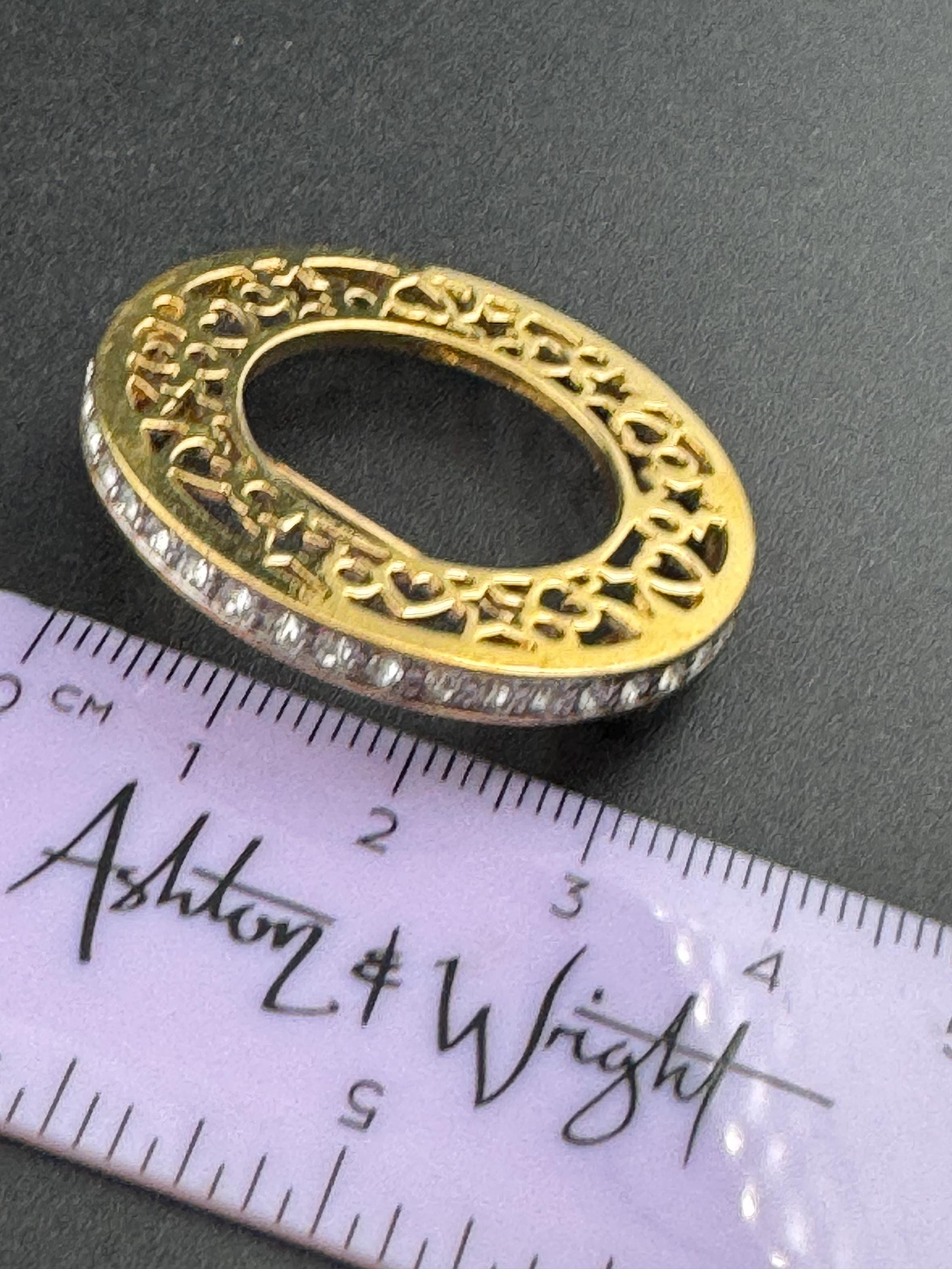 Vintage round openwork gold tone brooch channel set with clear rhinestones , sleek modernist design