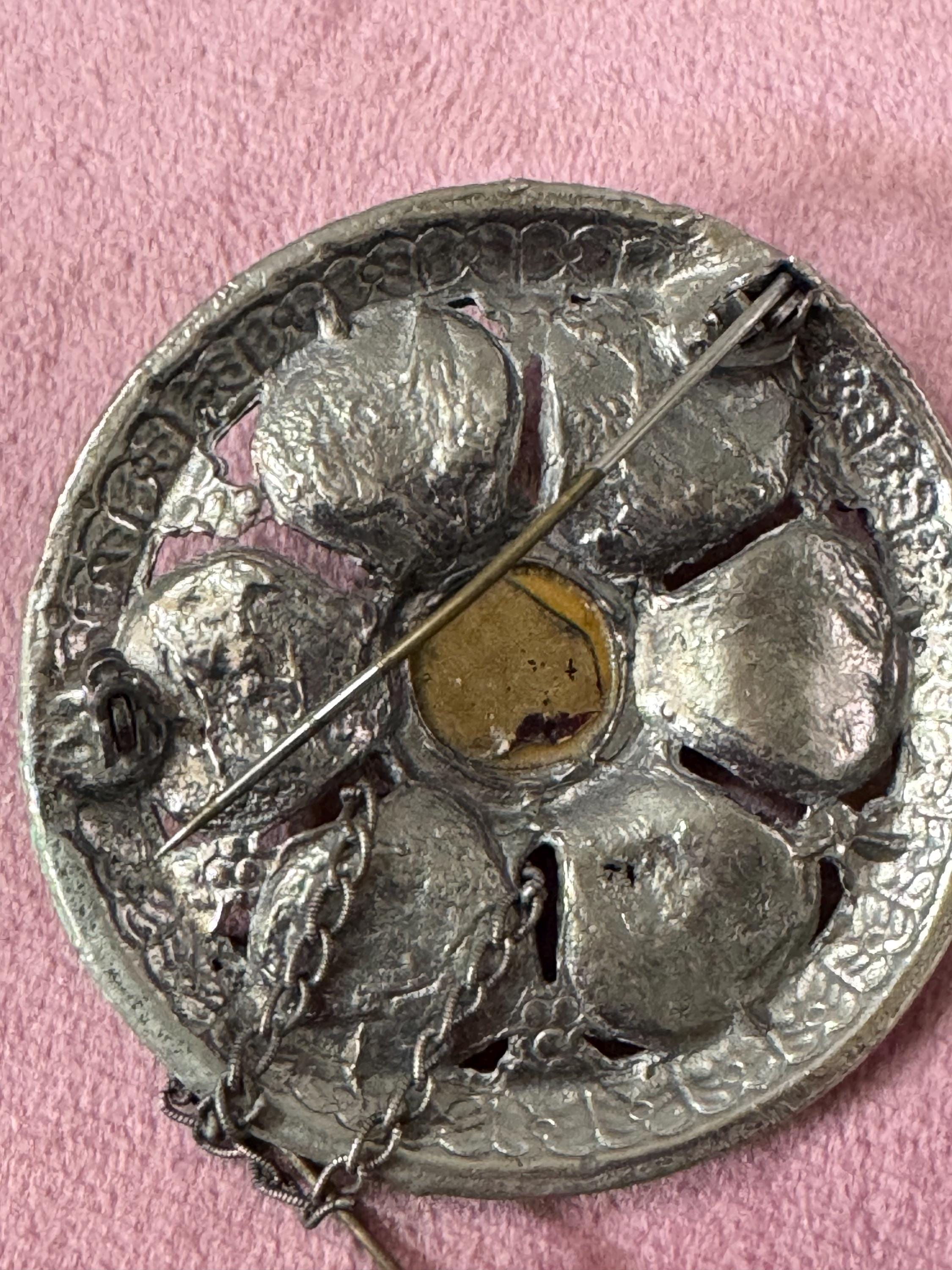 vintage round silver tone Etruscan figural faces large medallion shield brooch set with ruby faceted cabochon