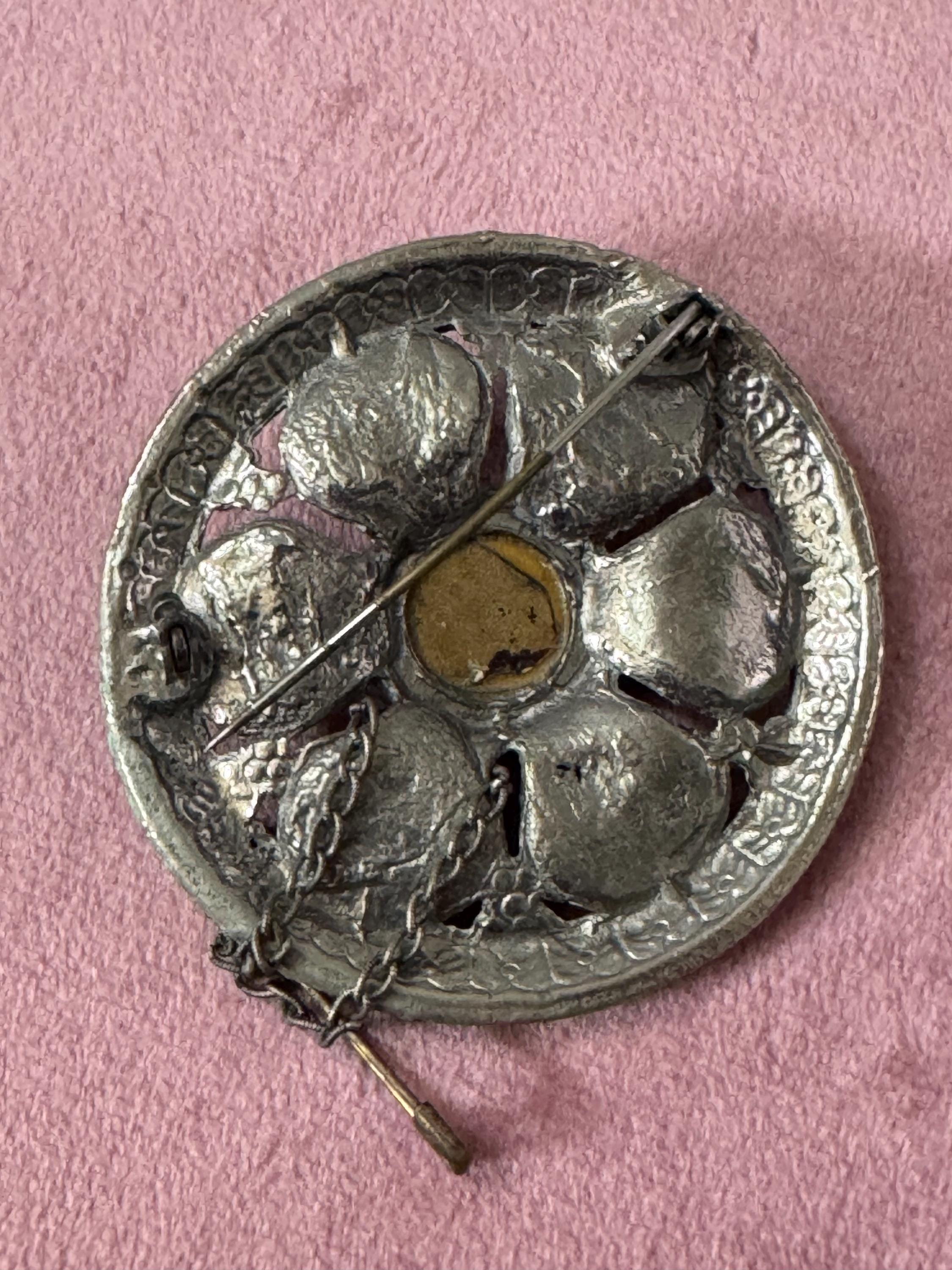 vintage round silver tone Etruscan figural faces large medallion shield brooch set with ruby faceted cabochon