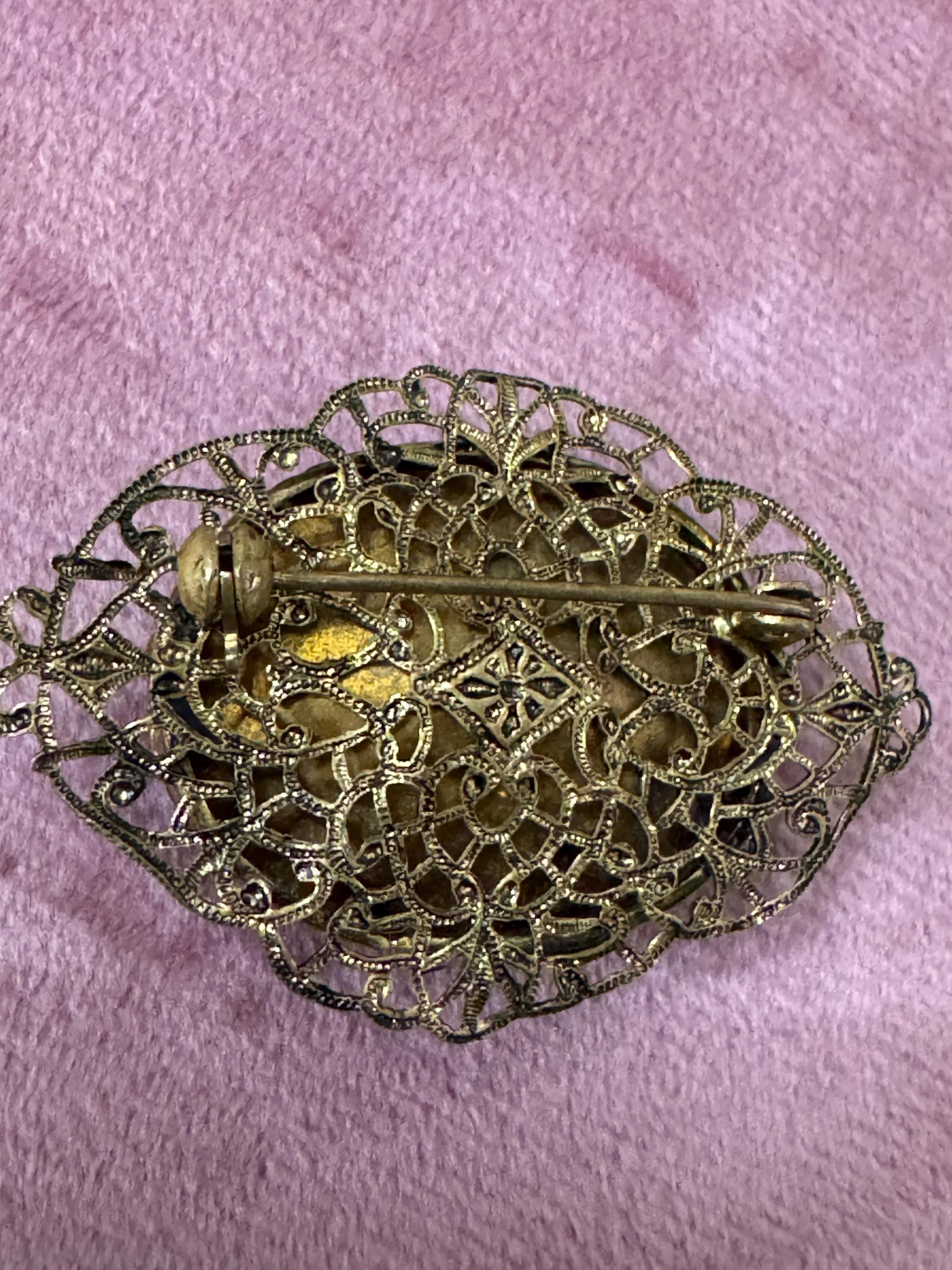 Antique Art Deco Czech brass gilt metal filigree brooch with red faux ruby glass paste rhinestones ornate