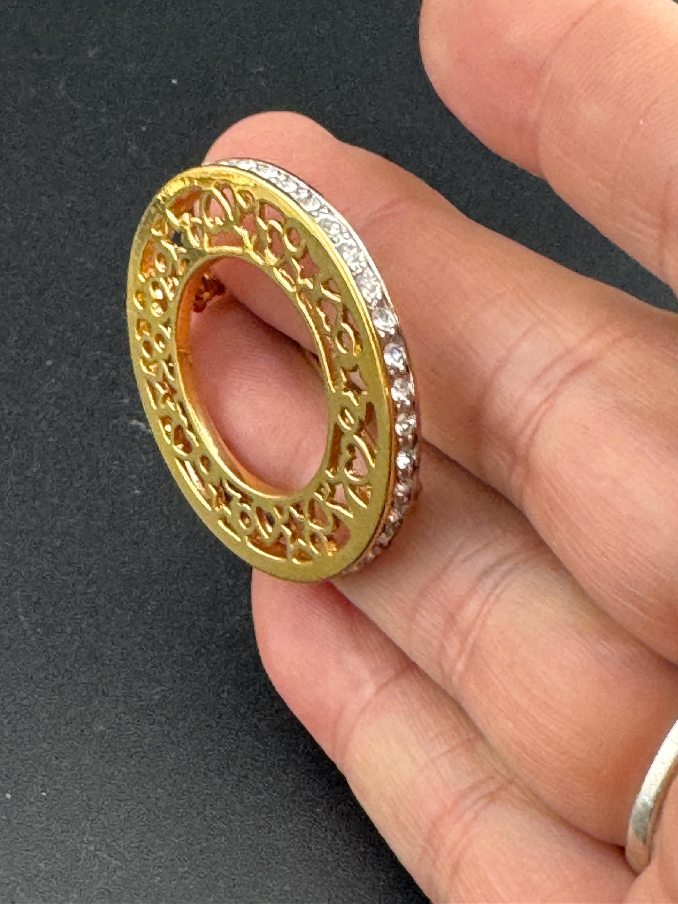 Vintage round openwork gold tone brooch channel set with clear rhinestones , sleek modernist design