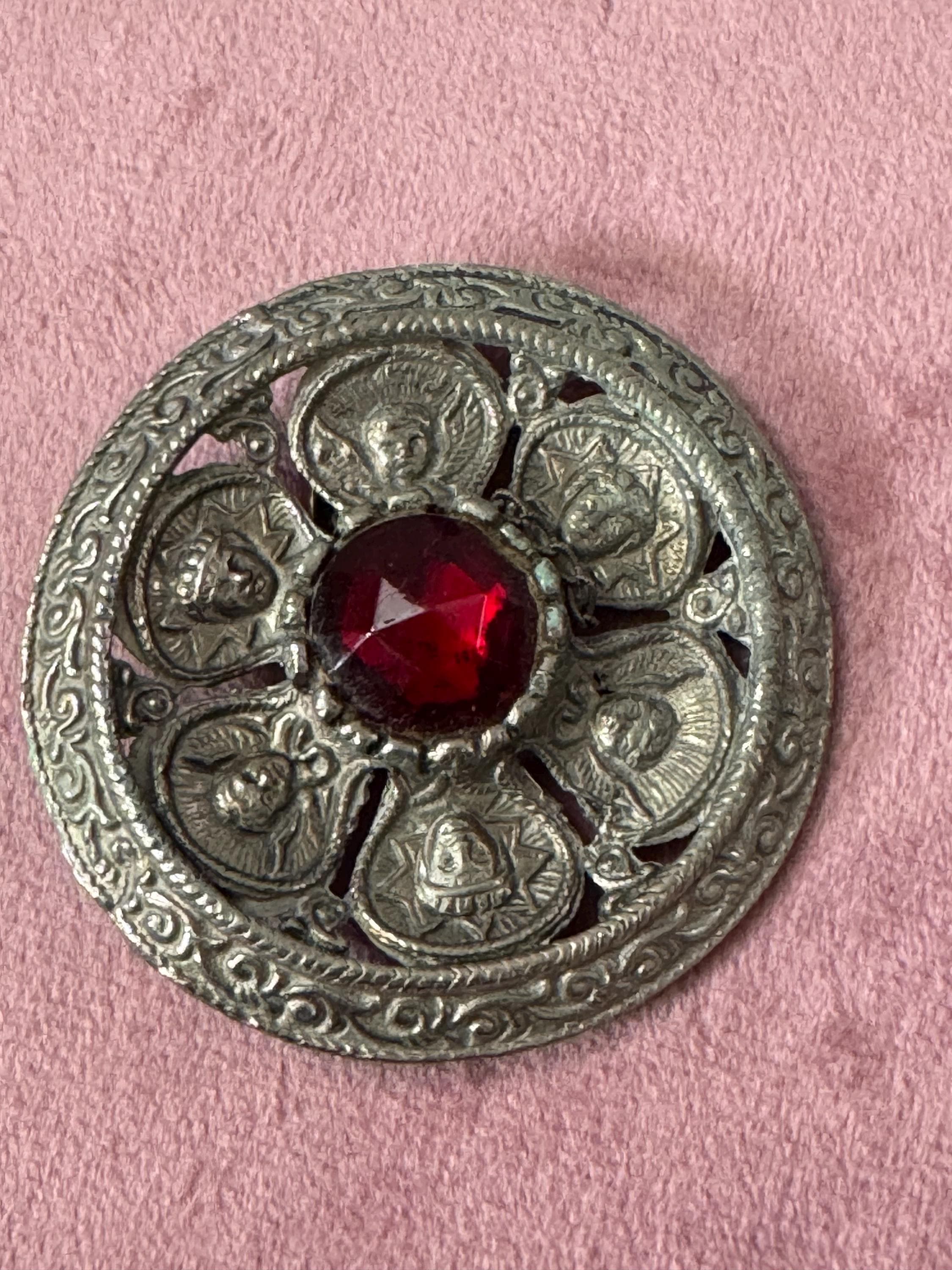 vintage round silver tone Etruscan figural faces large medallion shield brooch set with ruby faceted cabochon