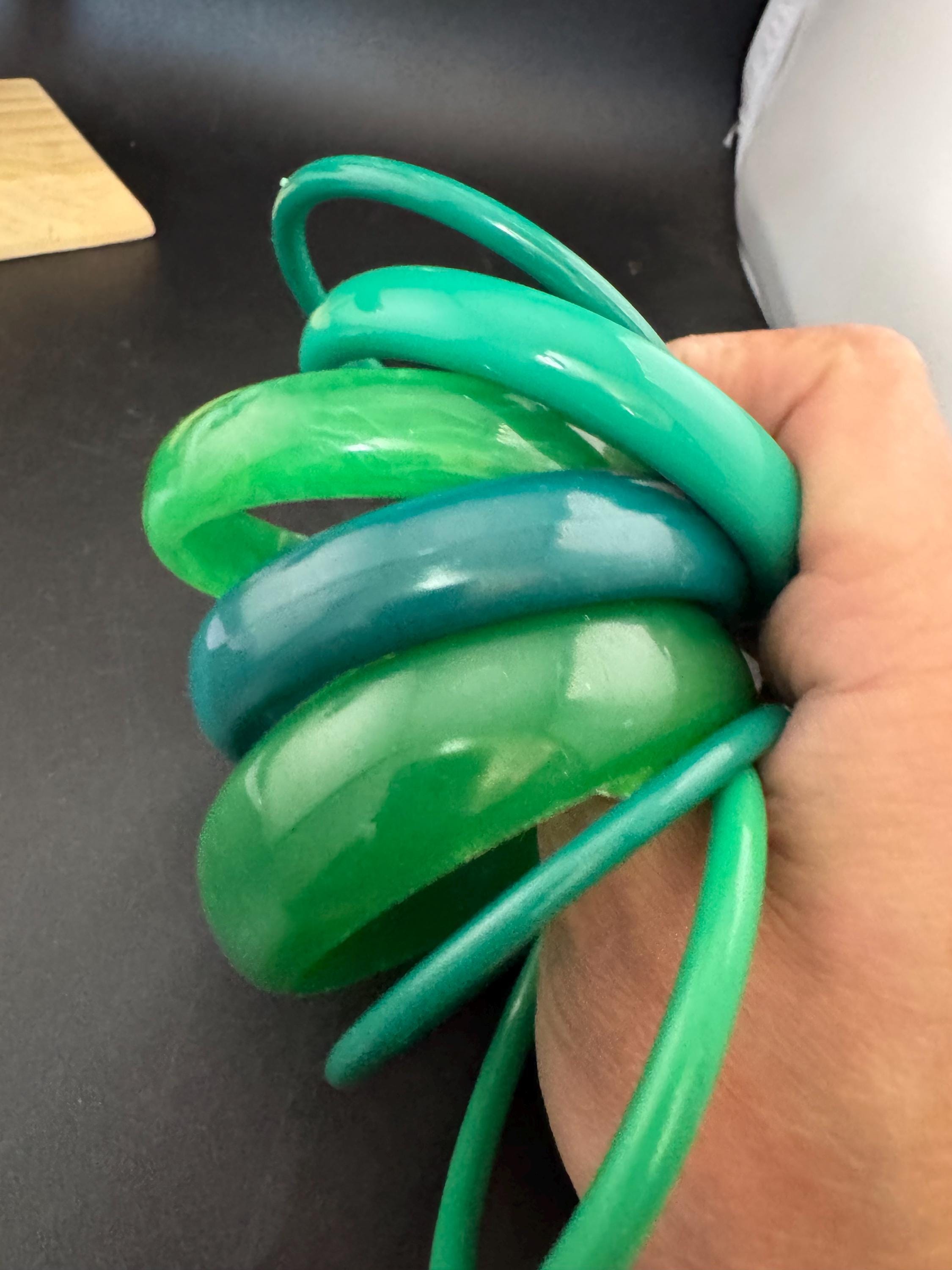 Vintage and retro curated stack of GREEN plastic acrylic bangles, bracelets
