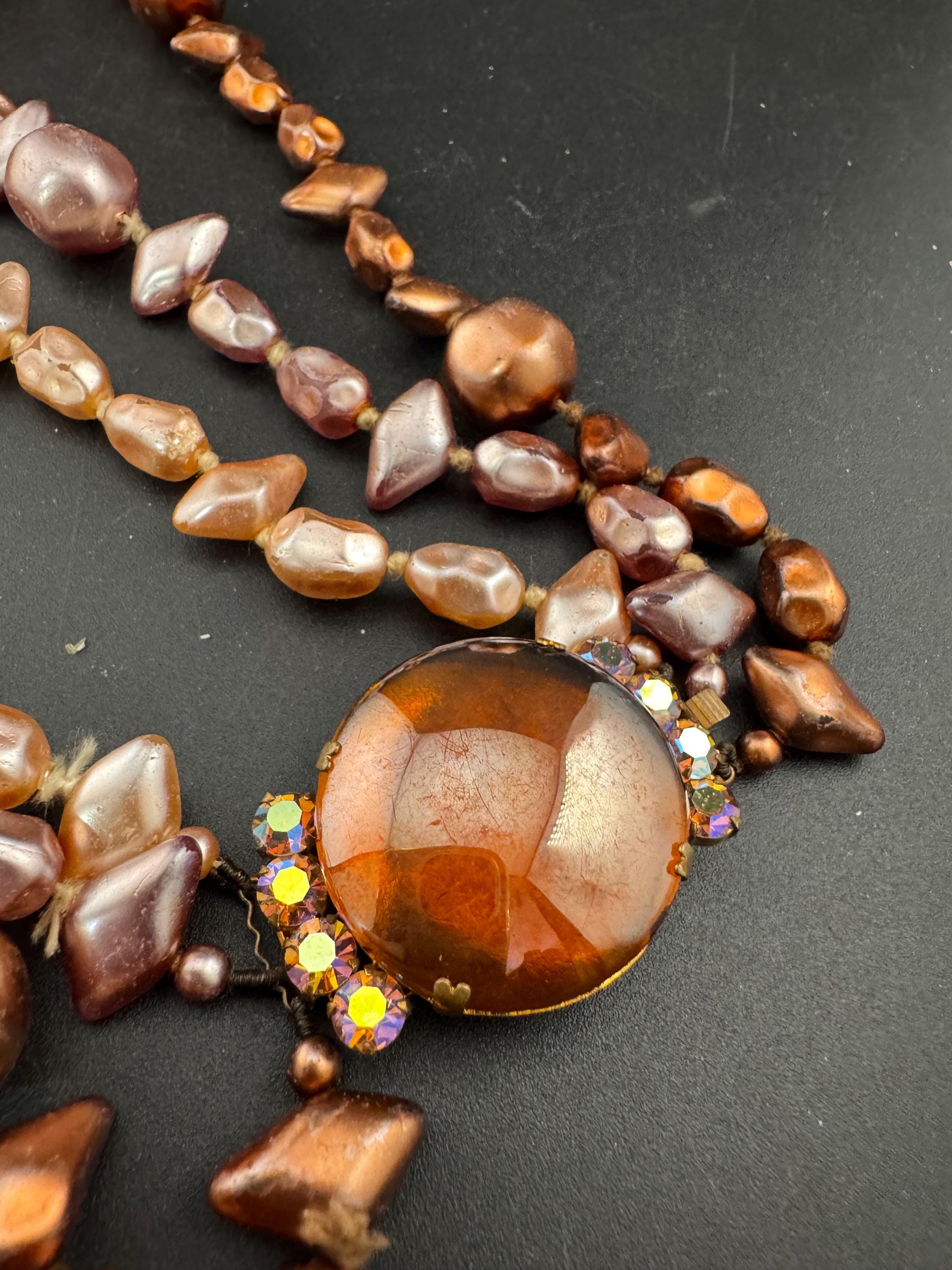 Fantastic Vintage triple strand row brown pink bronze glass faux pearl beaded multistrand necklace with a huge glass cabochon clasp