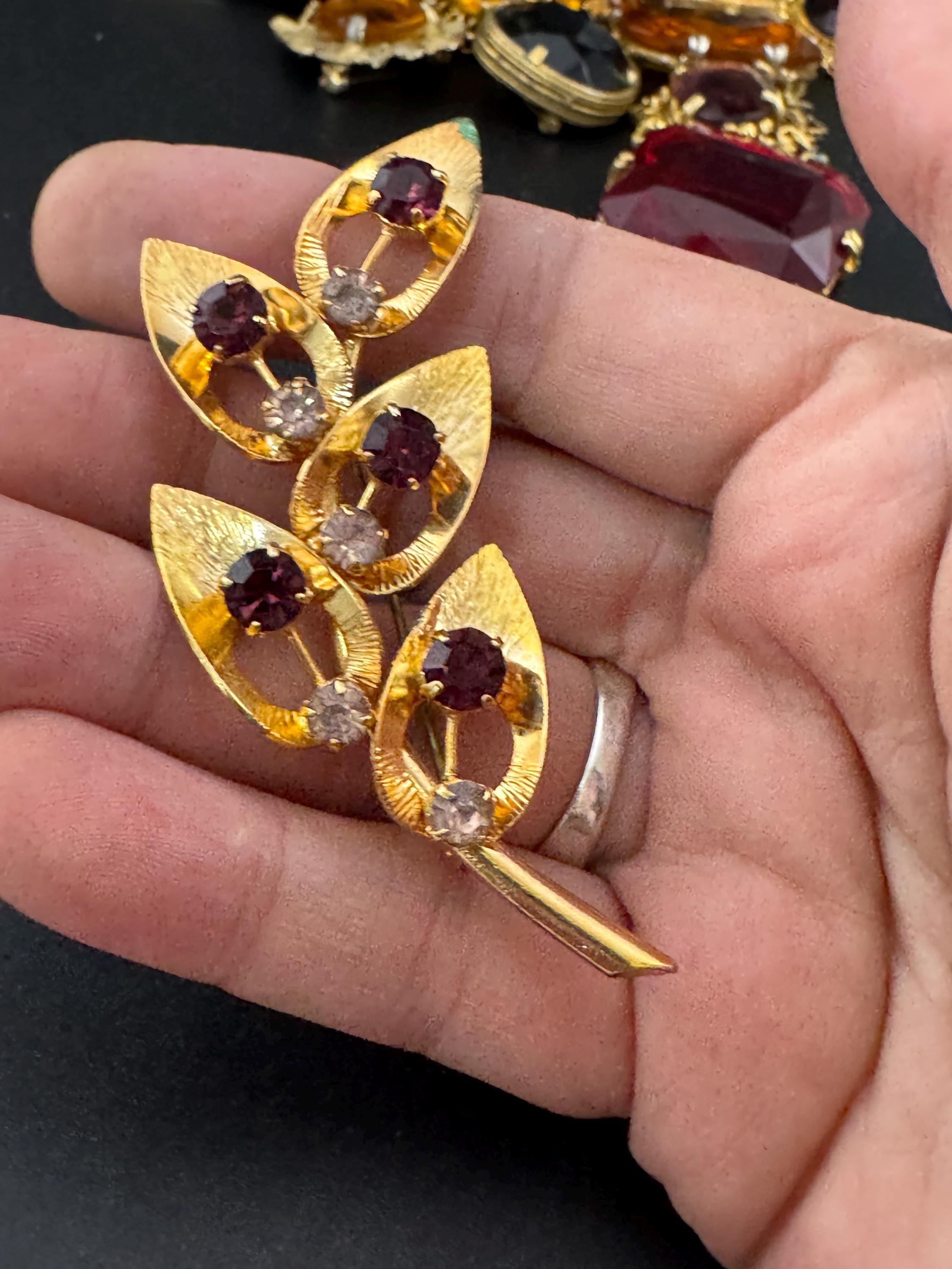 Vintage dark amethyst purple glass rhinestone gold plated floral brooch , mid century