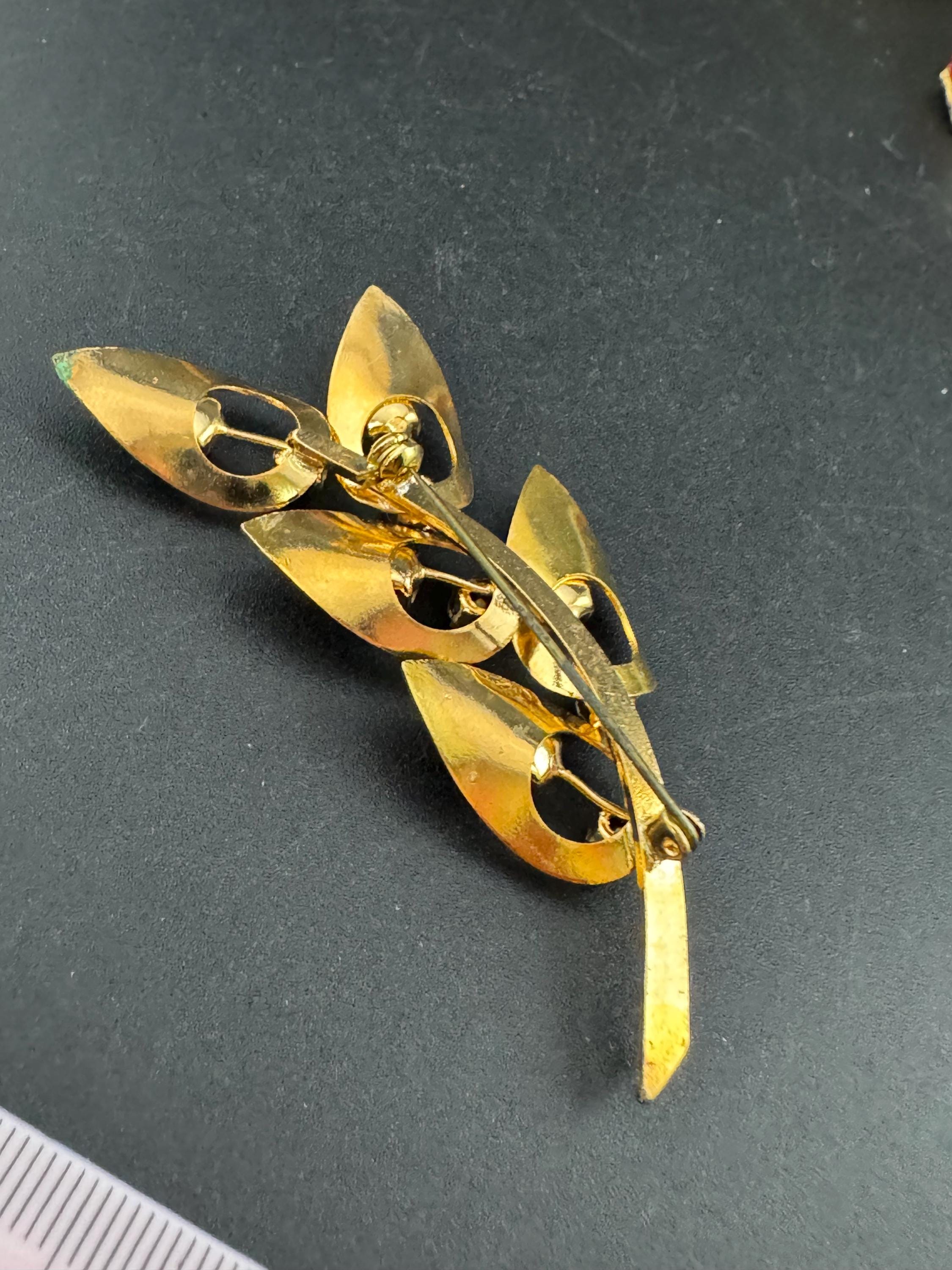 Vintage dark amethyst purple glass rhinestone gold plated floral brooch , mid century