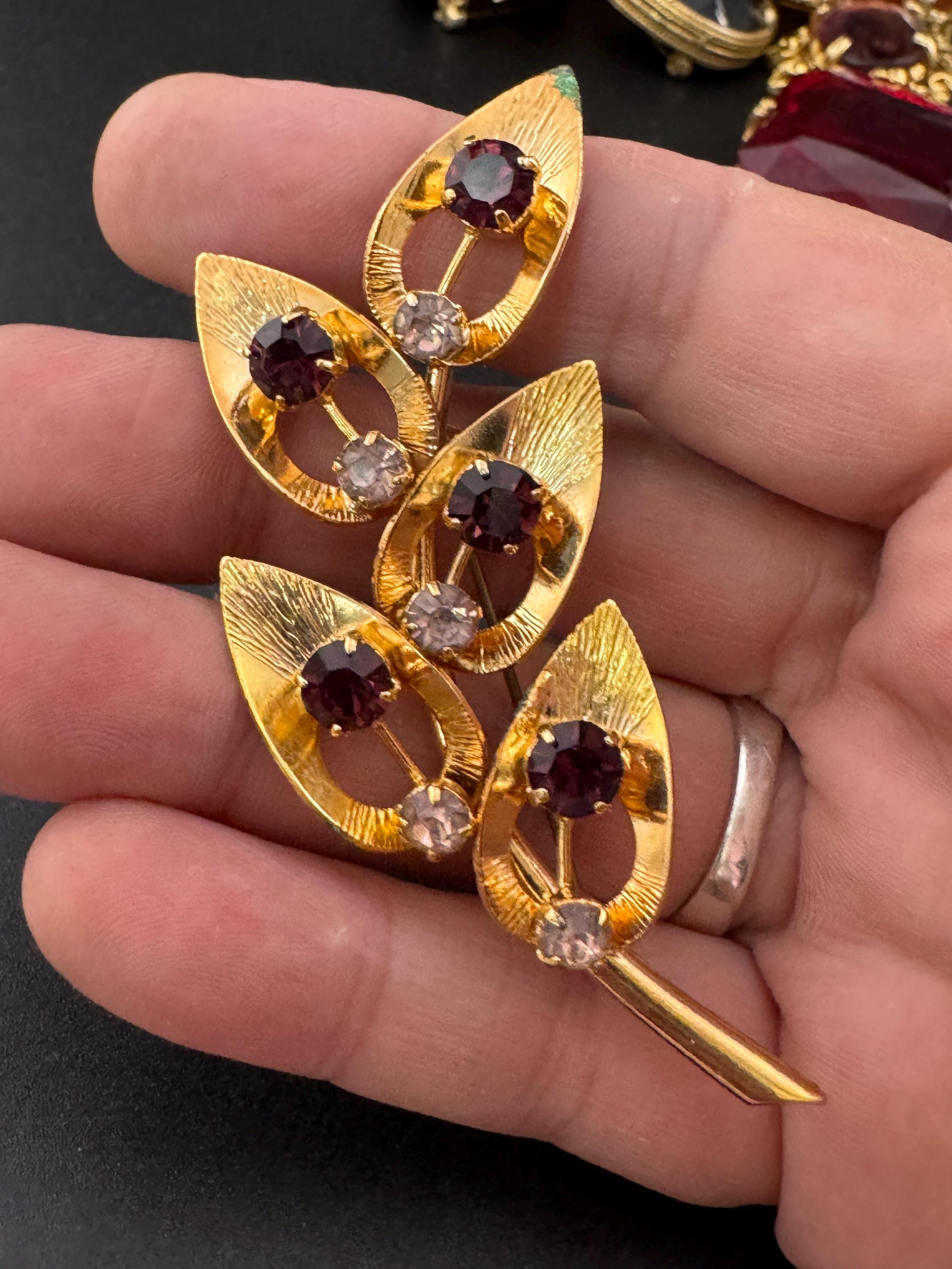Vintage dark amethyst purple glass rhinestone gold plated floral brooch , mid century