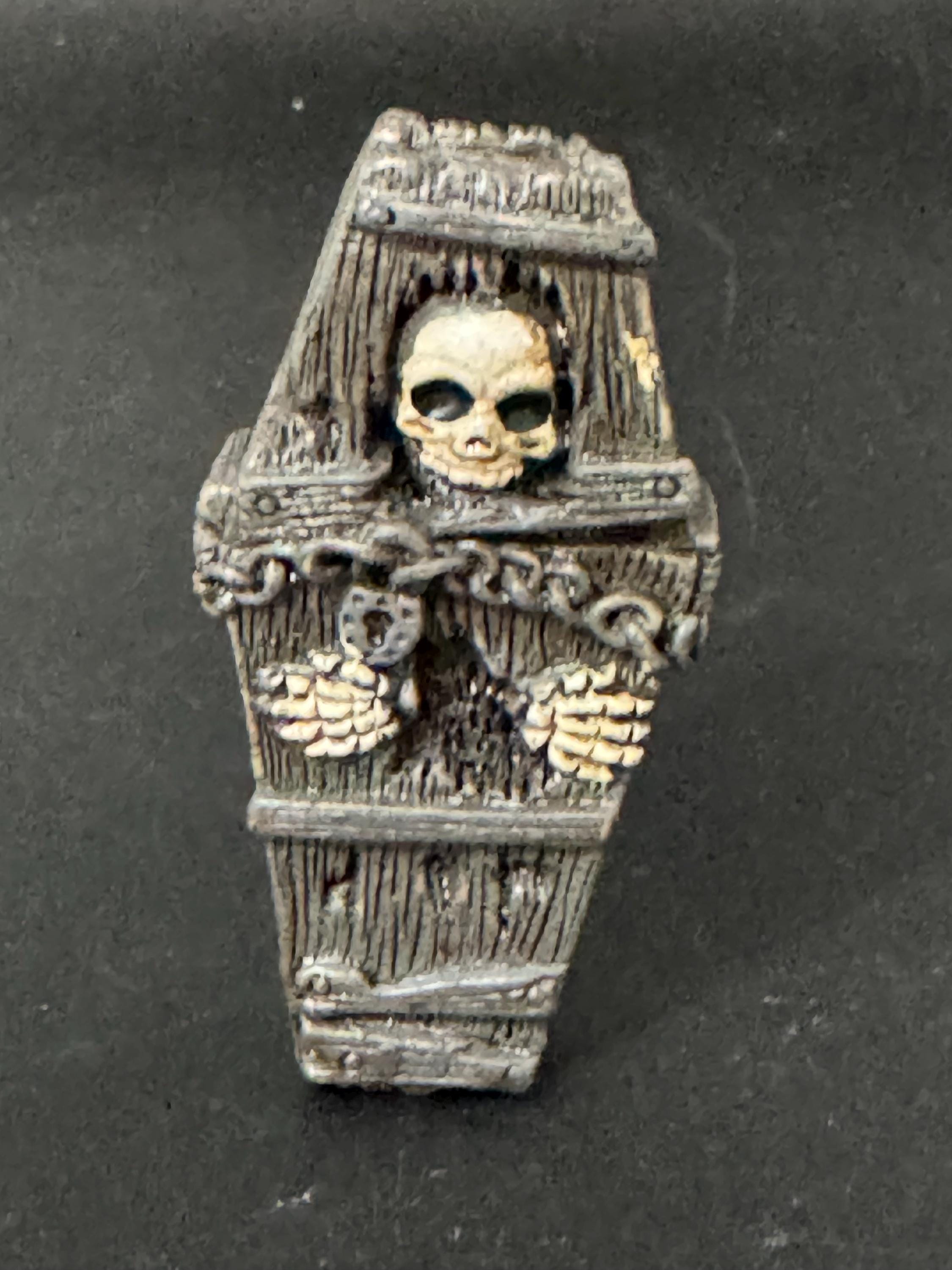 Miniature spooky Halloween skeleton in a coffin cake topper decorations, craft scenery, reusable plastic