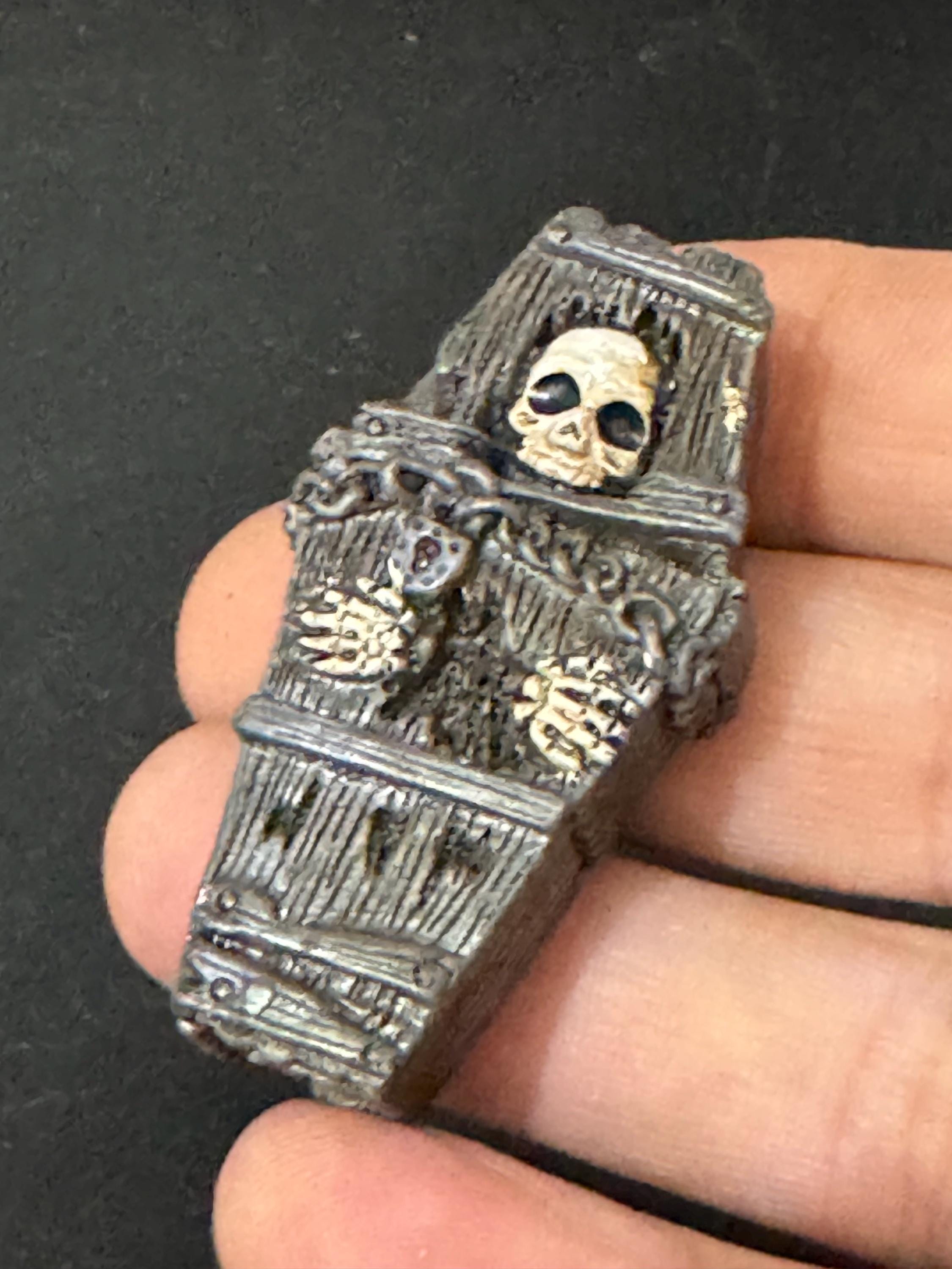 Miniature spooky Halloween skeleton in a coffin cake topper decorations, craft scenery, reusable plastic
