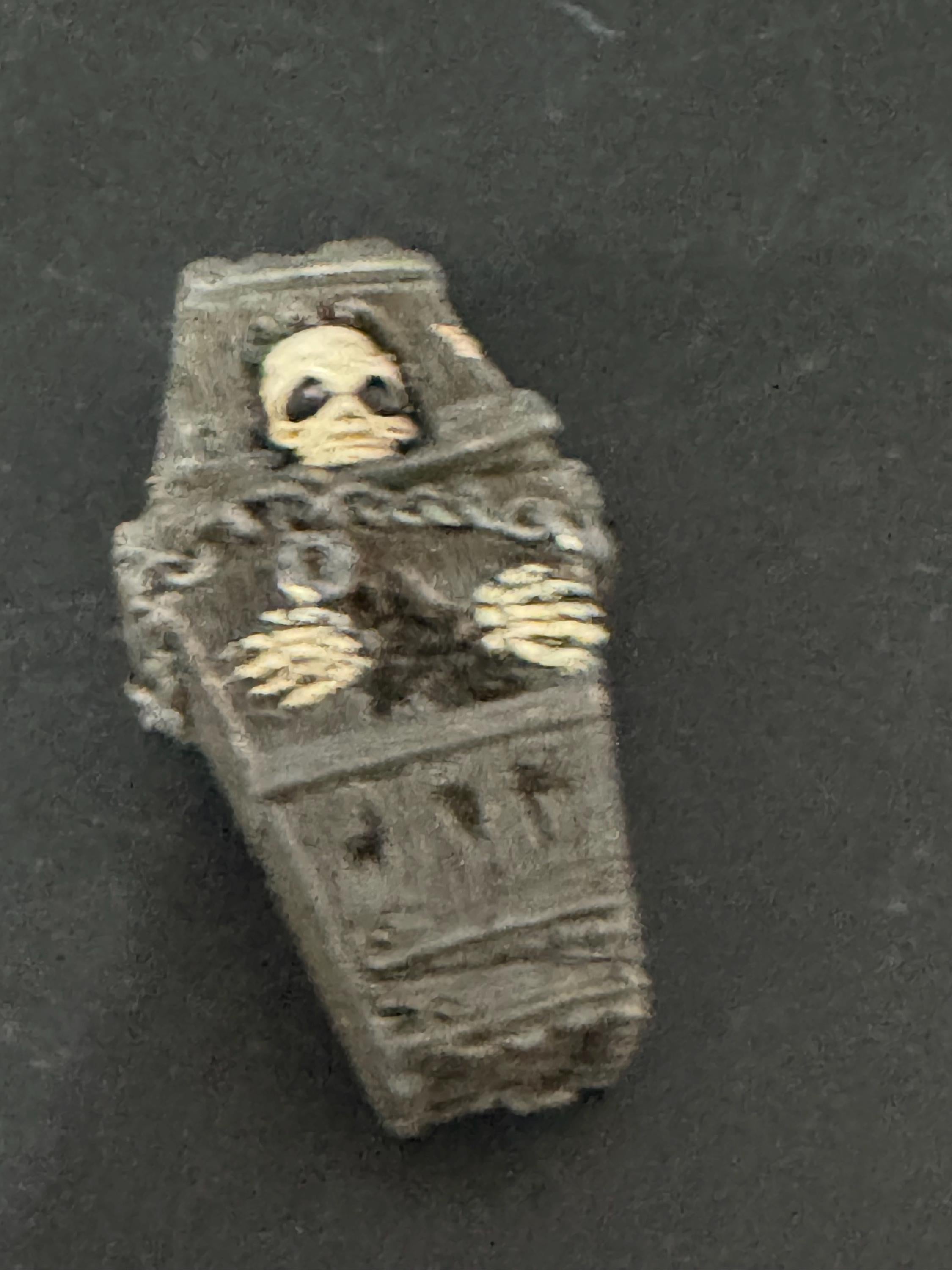 Miniature spooky Halloween skeleton in a coffin cake topper decorations, craft scenery, reusable plastic