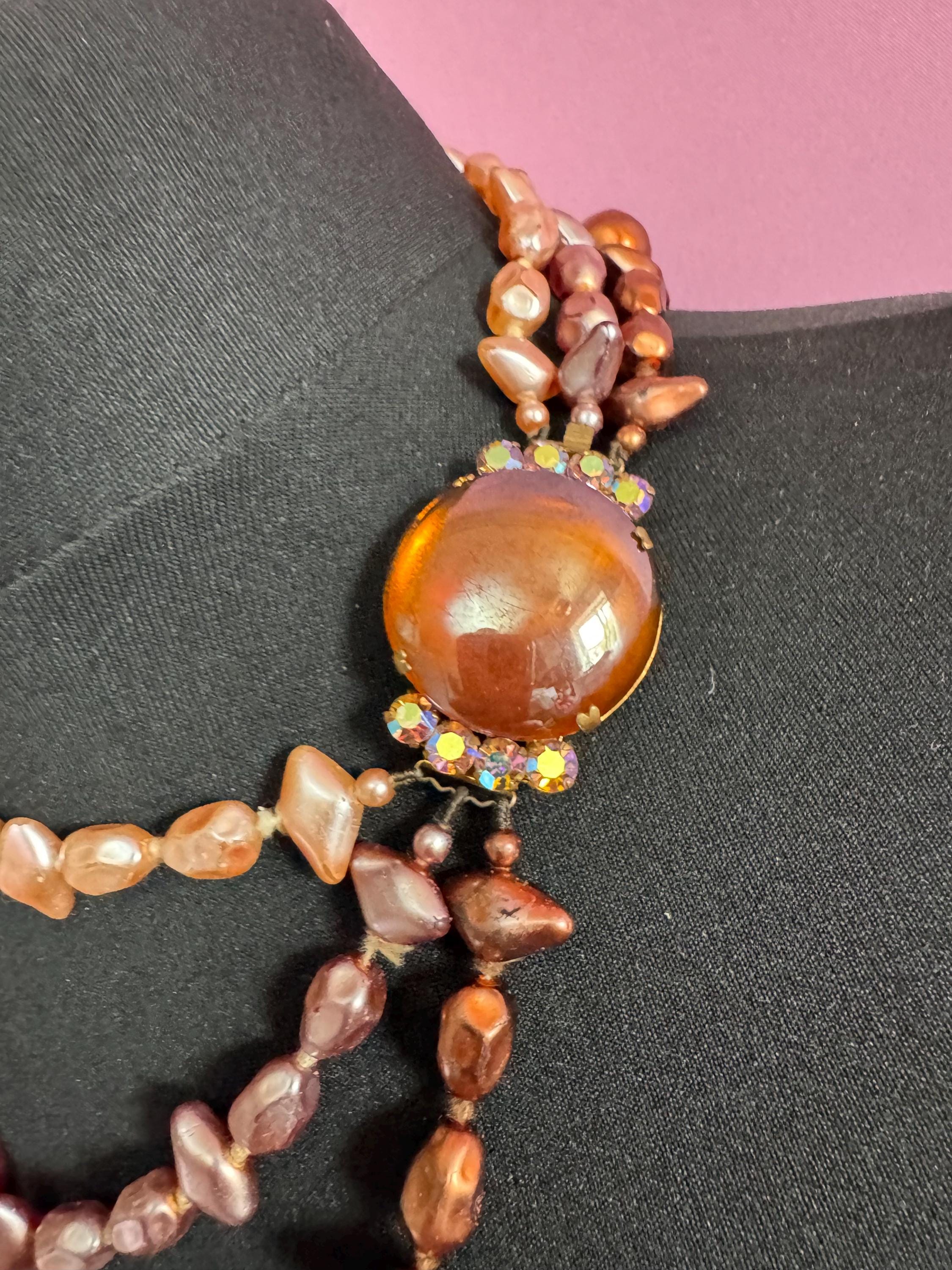 Fantastic Vintage triple strand row brown pink bronze glass faux pearl beaded multistrand necklace with a huge glass cabochon clasp