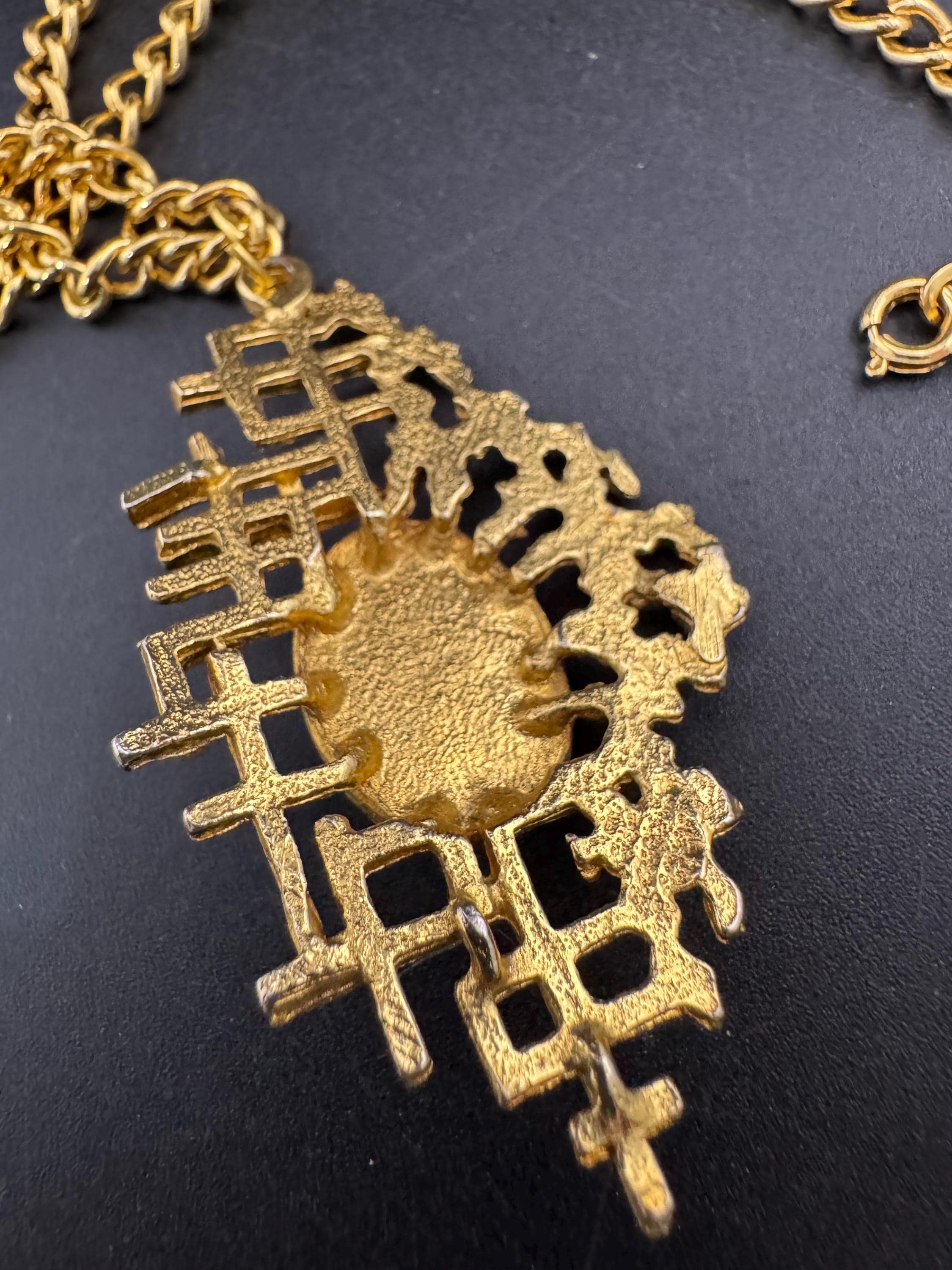 Vintage gold tone brutalist pendant with faux turquoise oval cabochon