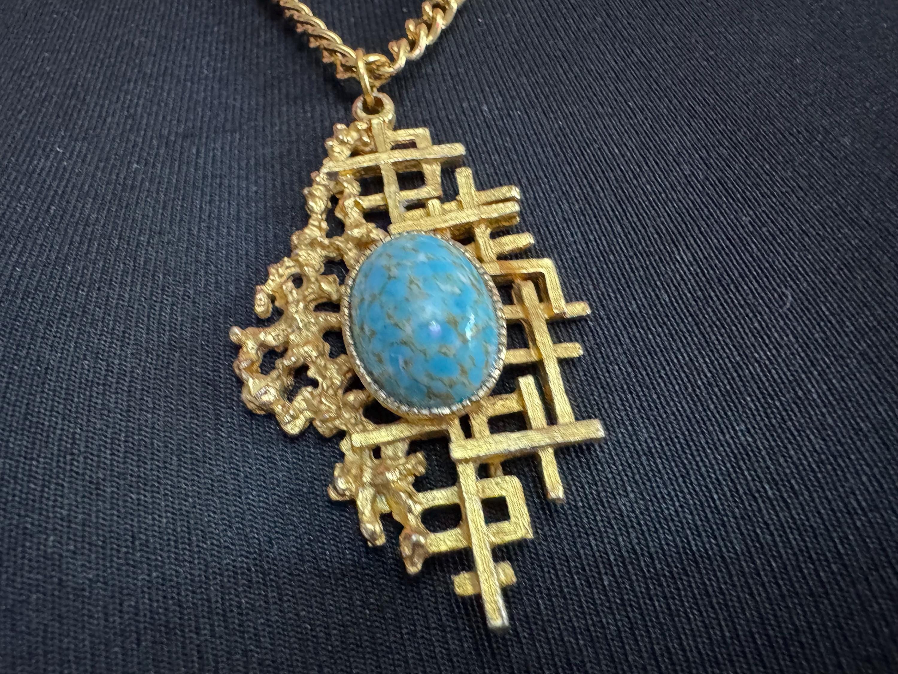 Vintage gold tone brutalist pendant with faux turquoise oval cabochon
